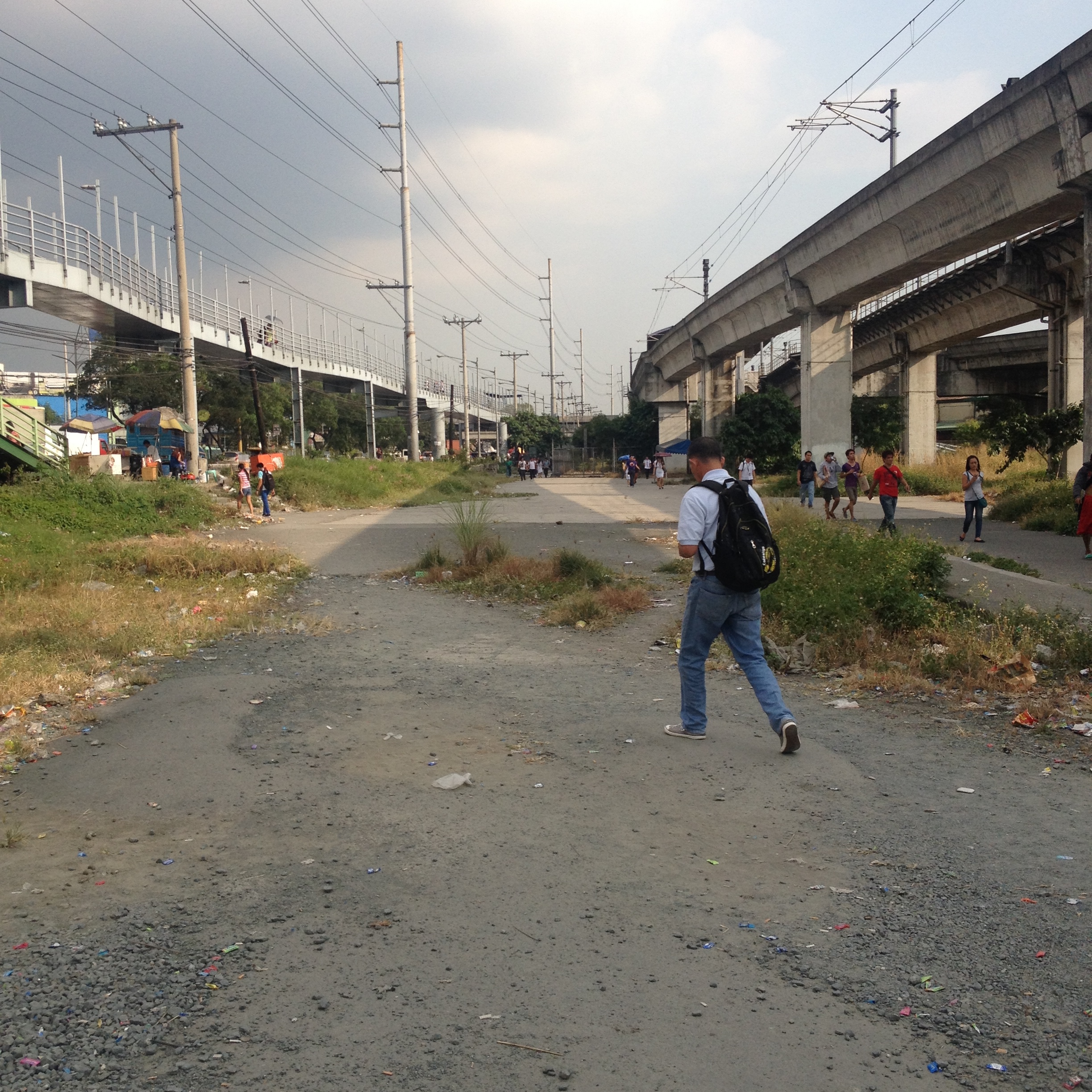 Next to the Santolan LRT station is a wide opening which people cross going from the station to the pedicabs and other jeepneys at the back. This could be transformed into a park and commuting hub with organized stations for jeepneys and tricycles and bike parking. Currently there is no where to park bicycles for those commuting from neighboring areas to the station. This is a primary station for both Marikina and Pasig, which brings people as far as Recto for shopping for instance at Divisoria. Jeepney use could be reduced by allowing people to park bicycles at this station. 