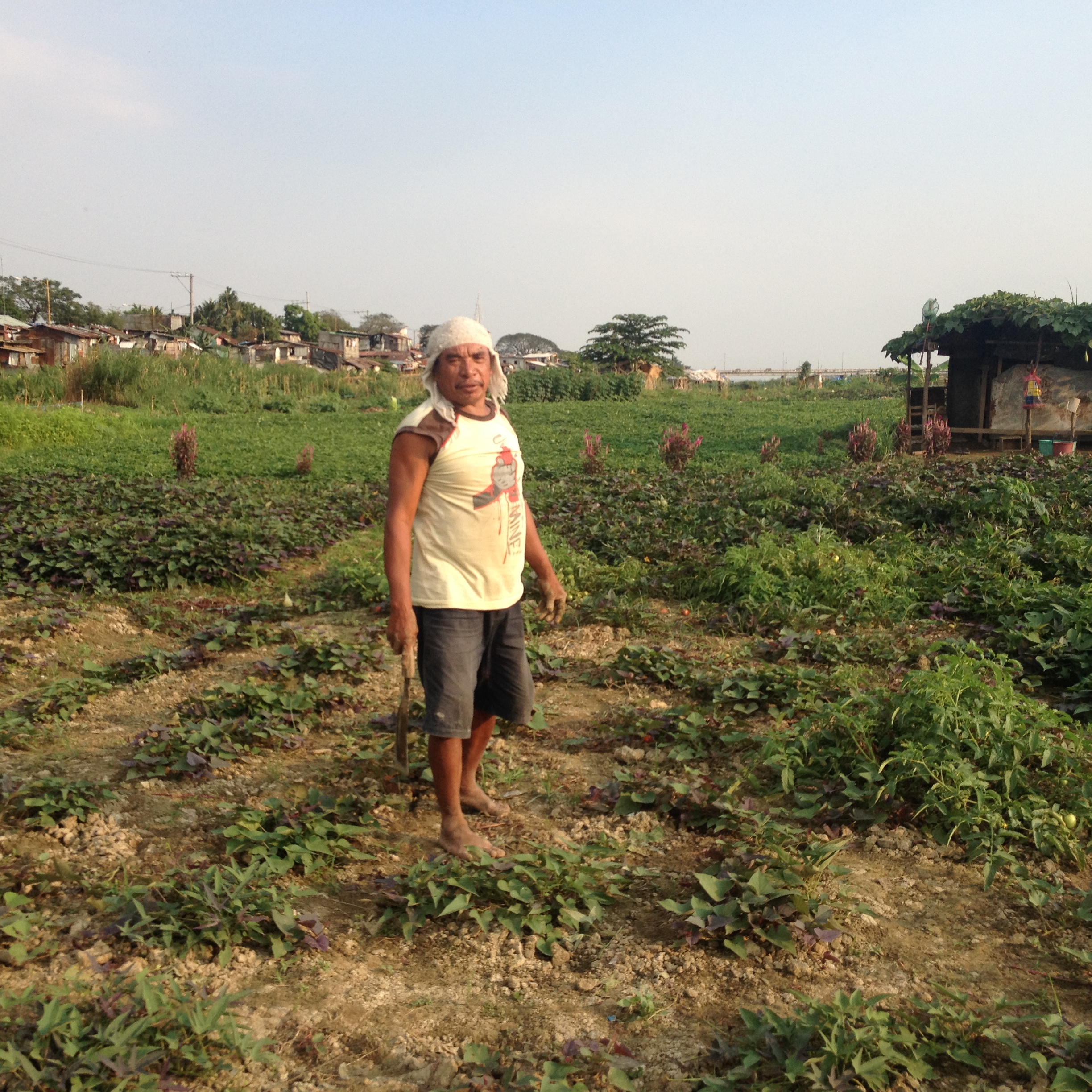 The farmers, such as this man, live in the informal houses lining the road along the floodway. 