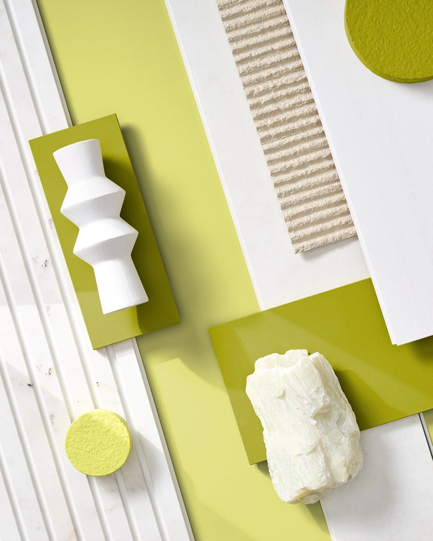 A bold and uplifting palette where zesty lime green meets off-white and soft ivory tones. This mood board explores the dynamic tension between matte surfaces, structured ridges, and sculptural forms. Textured stone, glossy lacquer, ribbed ceramics, a