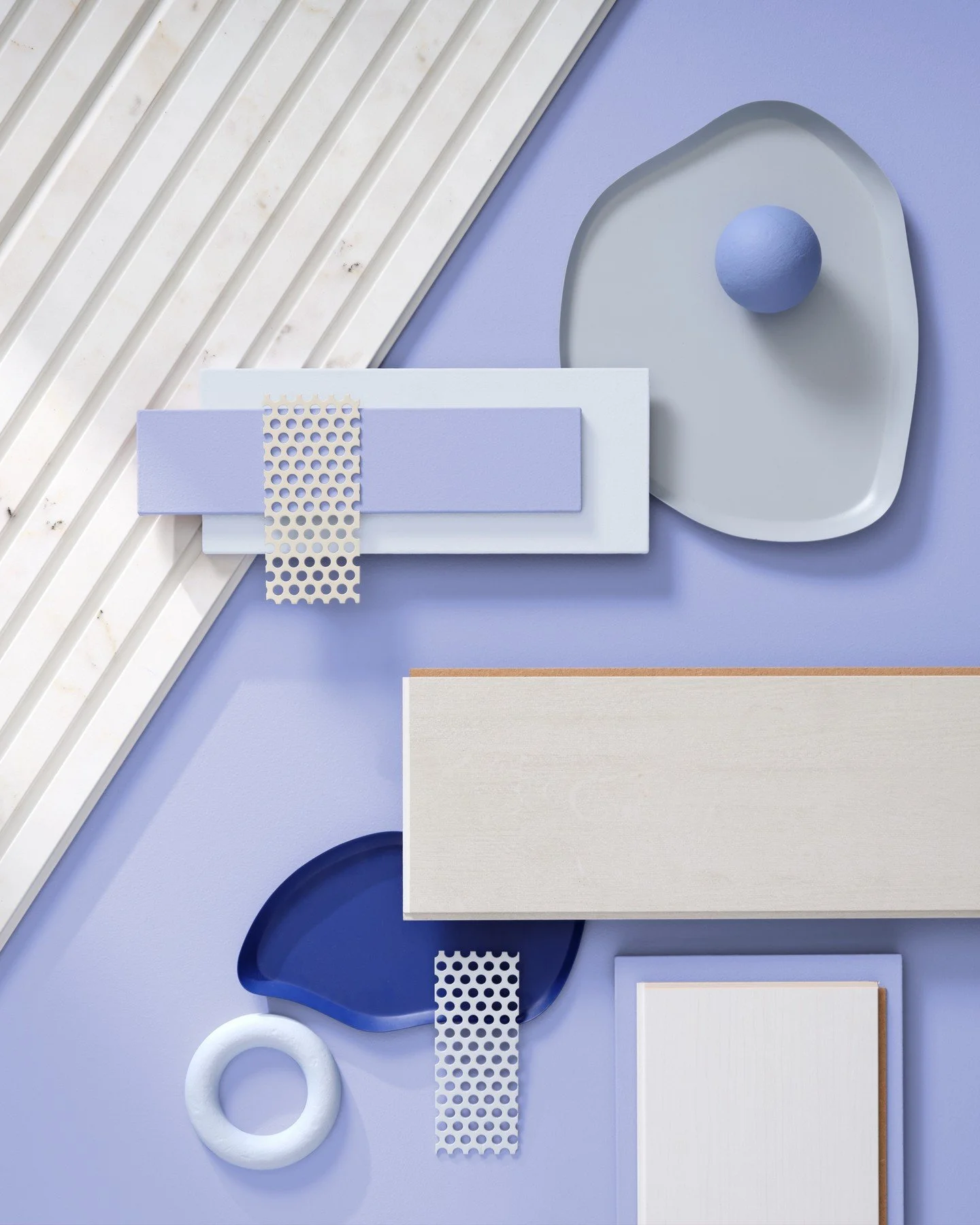 A calming play of cool tones and contemporary contrast. This mood board brings together soft lilac, slate blue, and crisp white with tactile materials like brushed wood, matte ceramics, powder-coated metal mesh, and ribbed marble. Shapes are geometri