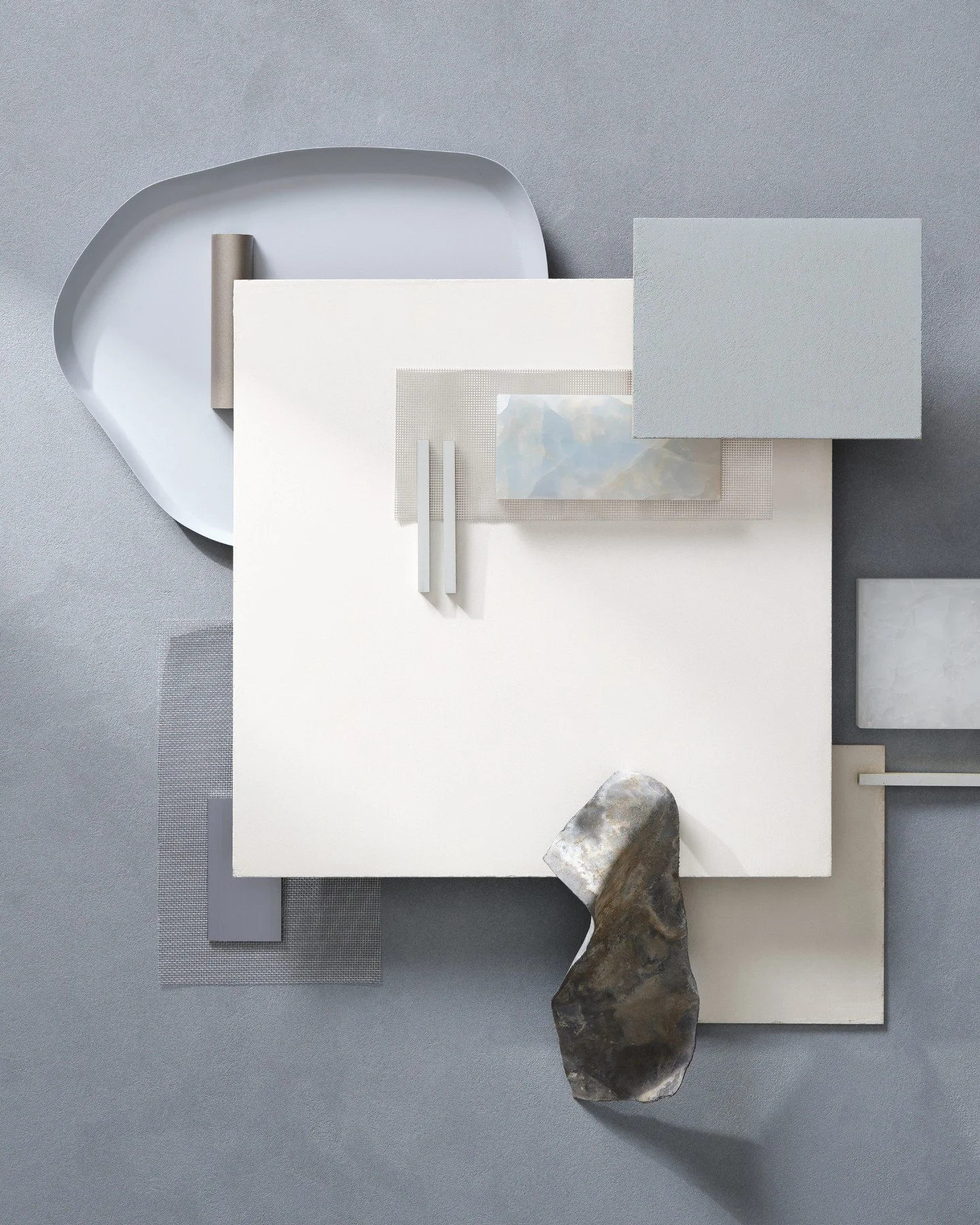 This mood board conveys a calm, refined minimalism with a cool, desaturated palette. Soft greys, off-whites, and pale blue tones dominate, creating a serene, almost meditative atmosphere. The materials—brushed metal, textured textiles, frosted