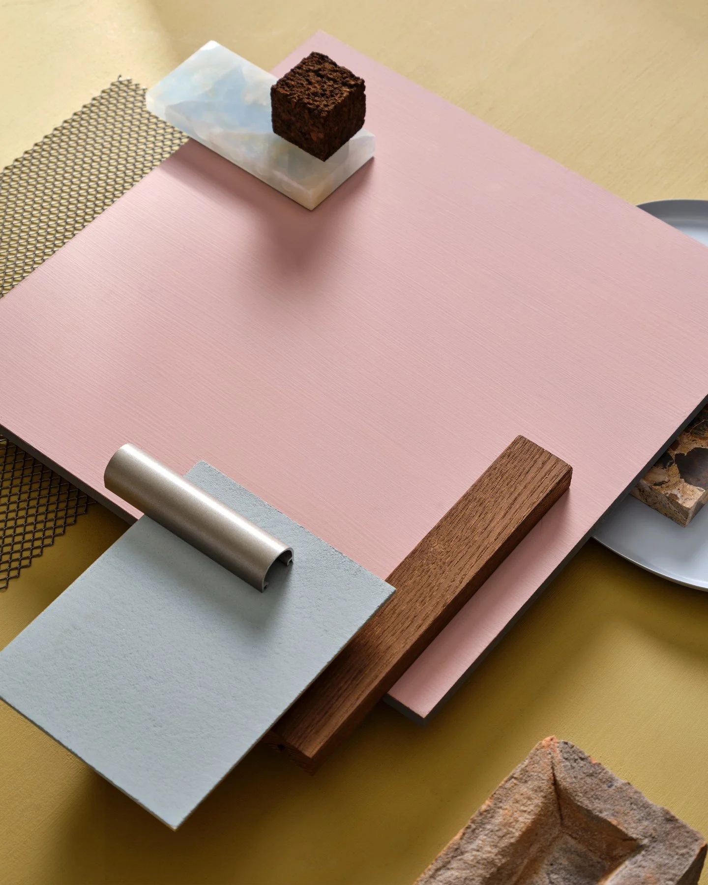 This moodboard presents a beautifully balanced palette of muted pastels and warm natural elements, merging soft femininity with grounded, tactile materials. The dusty pink and pale blue tones create a calming, modern atmosphere, while the yellow back