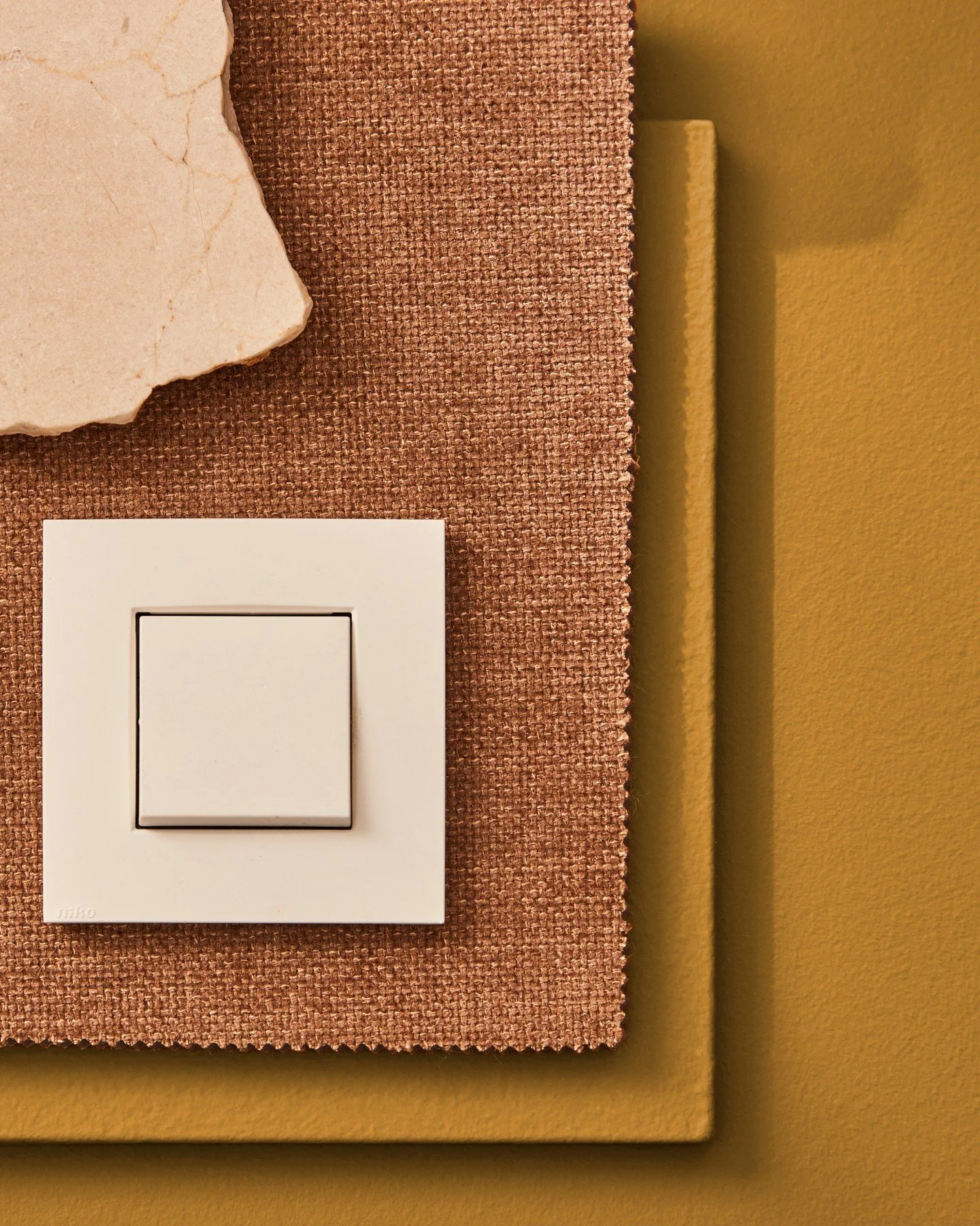A dialogue between texture and tone. Woven copper fabric, natural stone, and deep ochre come together to create a grounded, tactile composition. Designed to evoke warmth and balance, where raw materials meet clean, functional design.