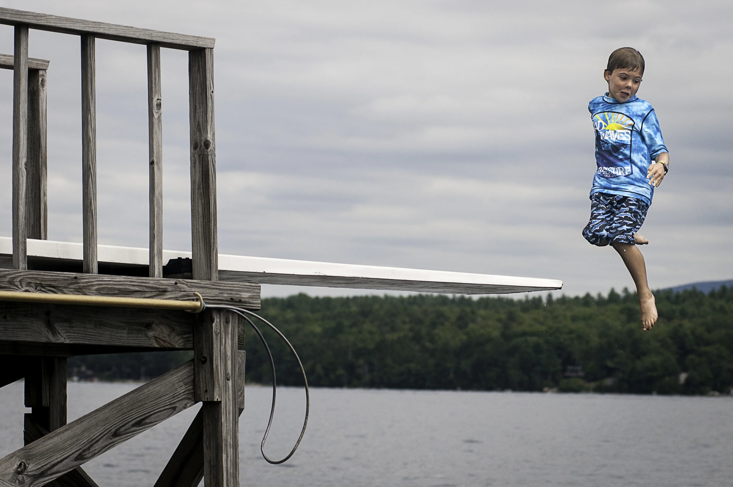 Jumping off the high diving board, Lake Sunapee Yacht Club, Sunapee, New Hampshire.