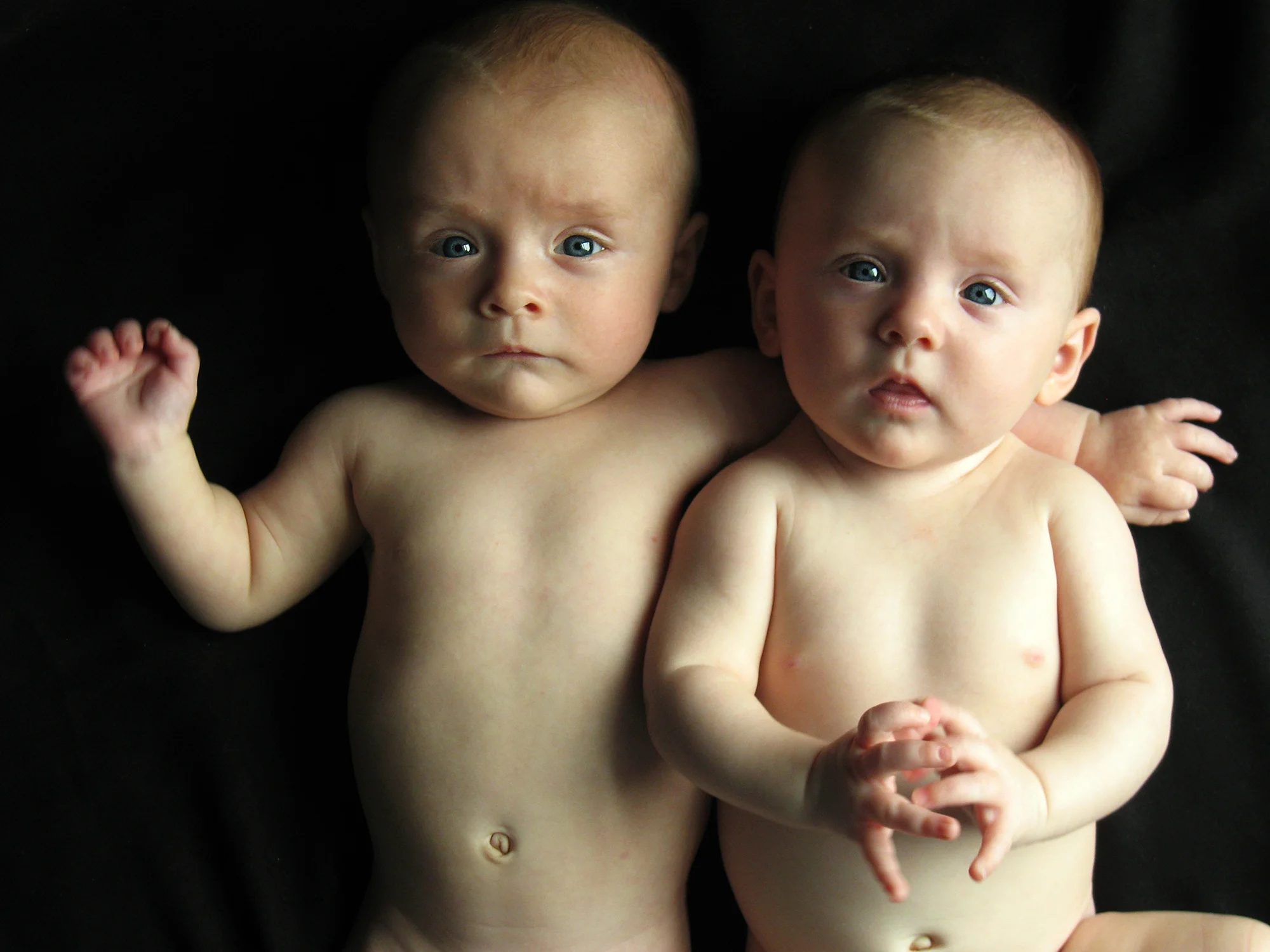 Fraternal boy and girl twins still look so much alike photographed at three months old.