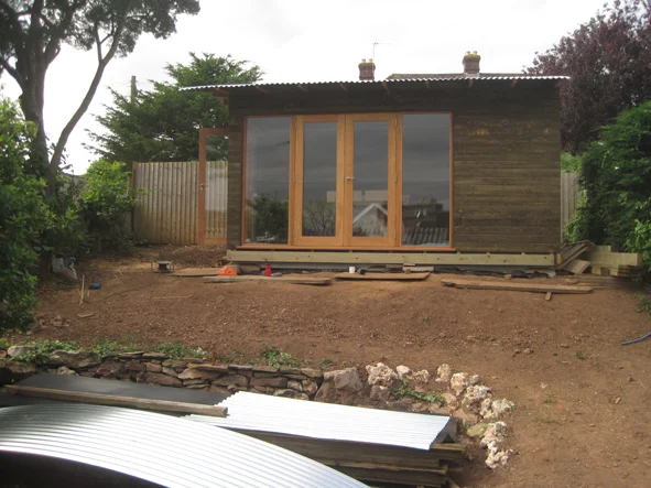 Clad + wiggly tin roof on