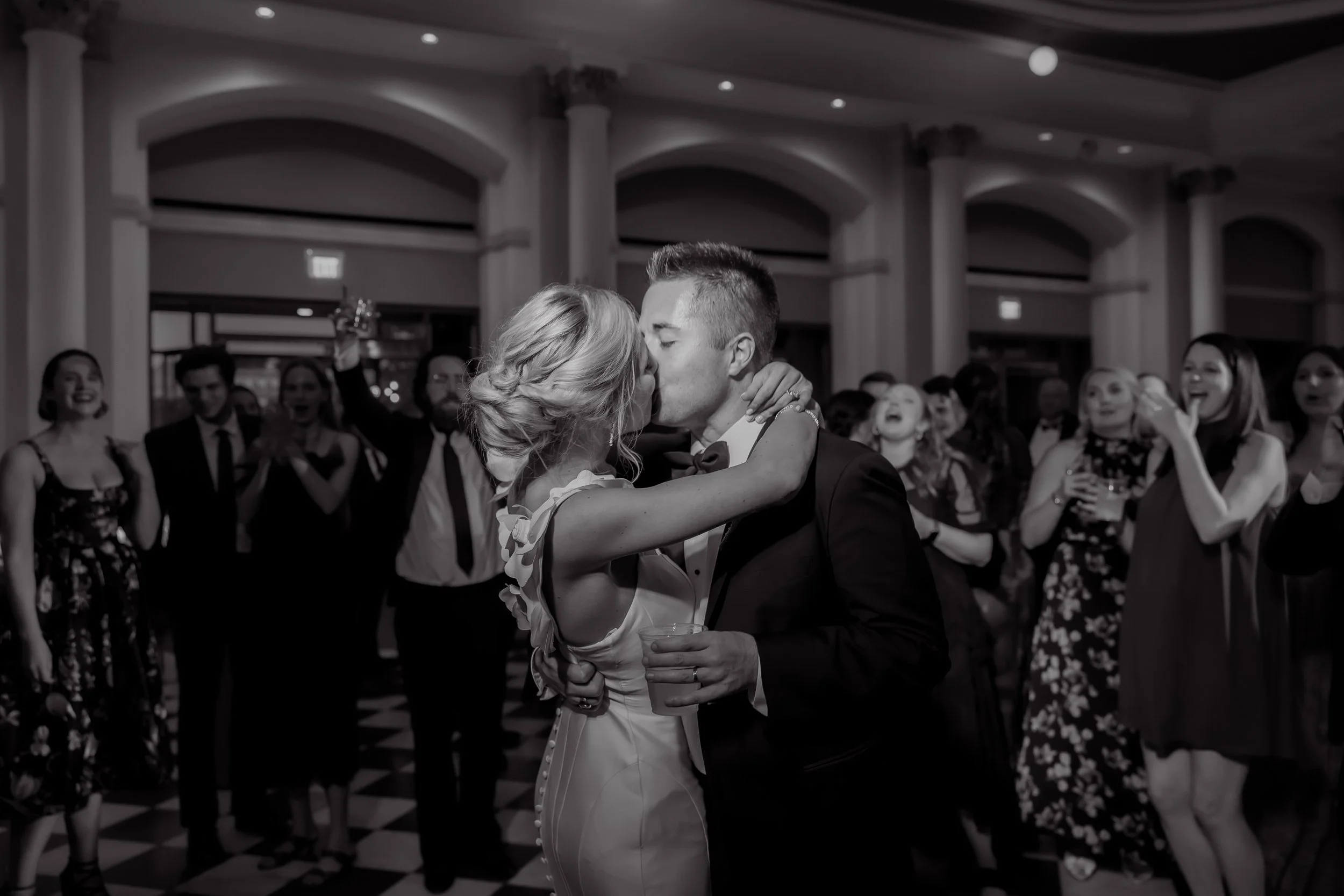 Music Hall Wedding Image of Couple Kissing in Reception in Black and White
