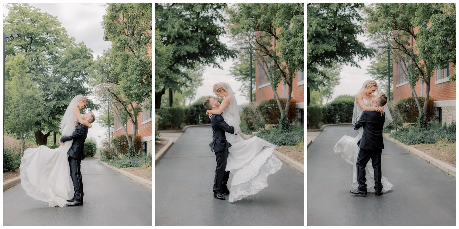 Groom picking up and carrying his bride, twirling and smling at her.