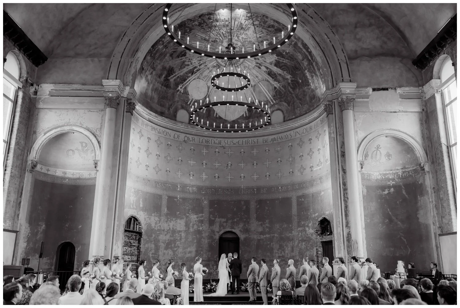 Black and white wide angle image of the wedding ceremony showcasing the intererior of the Monastery Event Center in Cincinnati.