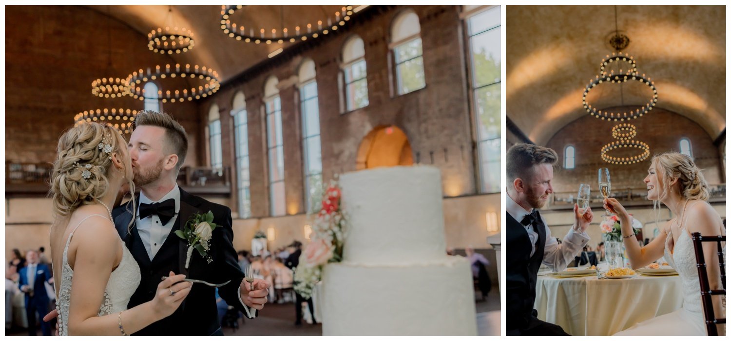 The bride and groom kissing and cheersing at their wedding reception under the glowing lights.