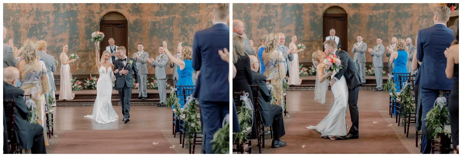 Celebratory end of the wedding ceremony bride and groom dipping, kissing, and cheering, inside the Monastery Event Center in Cincinnati.