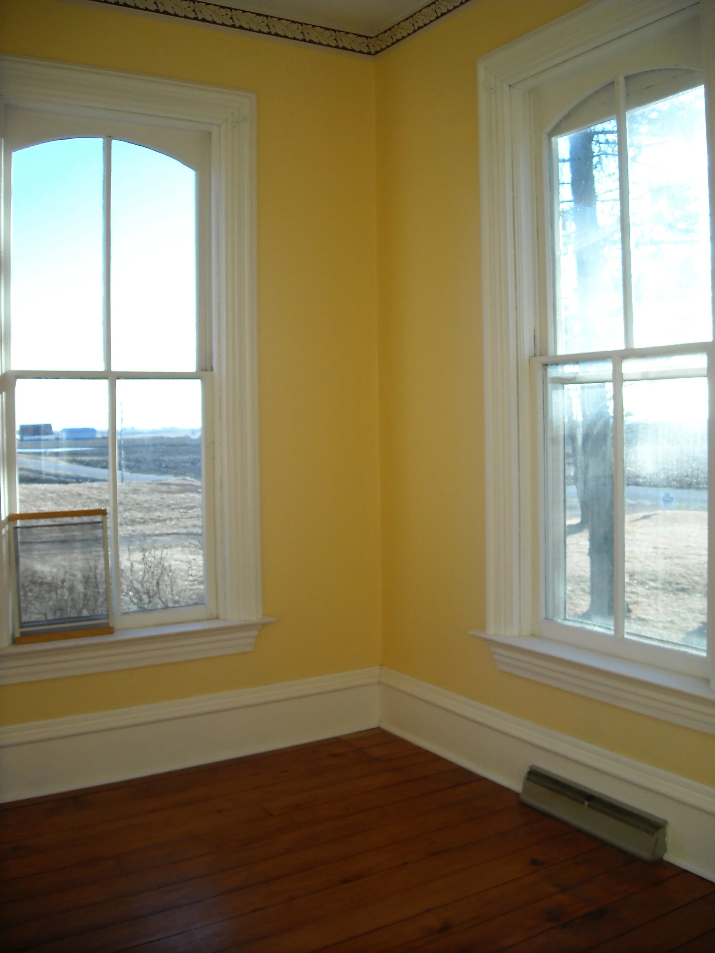 On the inside it's clear the windows are rectangular at the top, with the glass sections in the upper sash arched (the window on the right has a storm window over the outside).