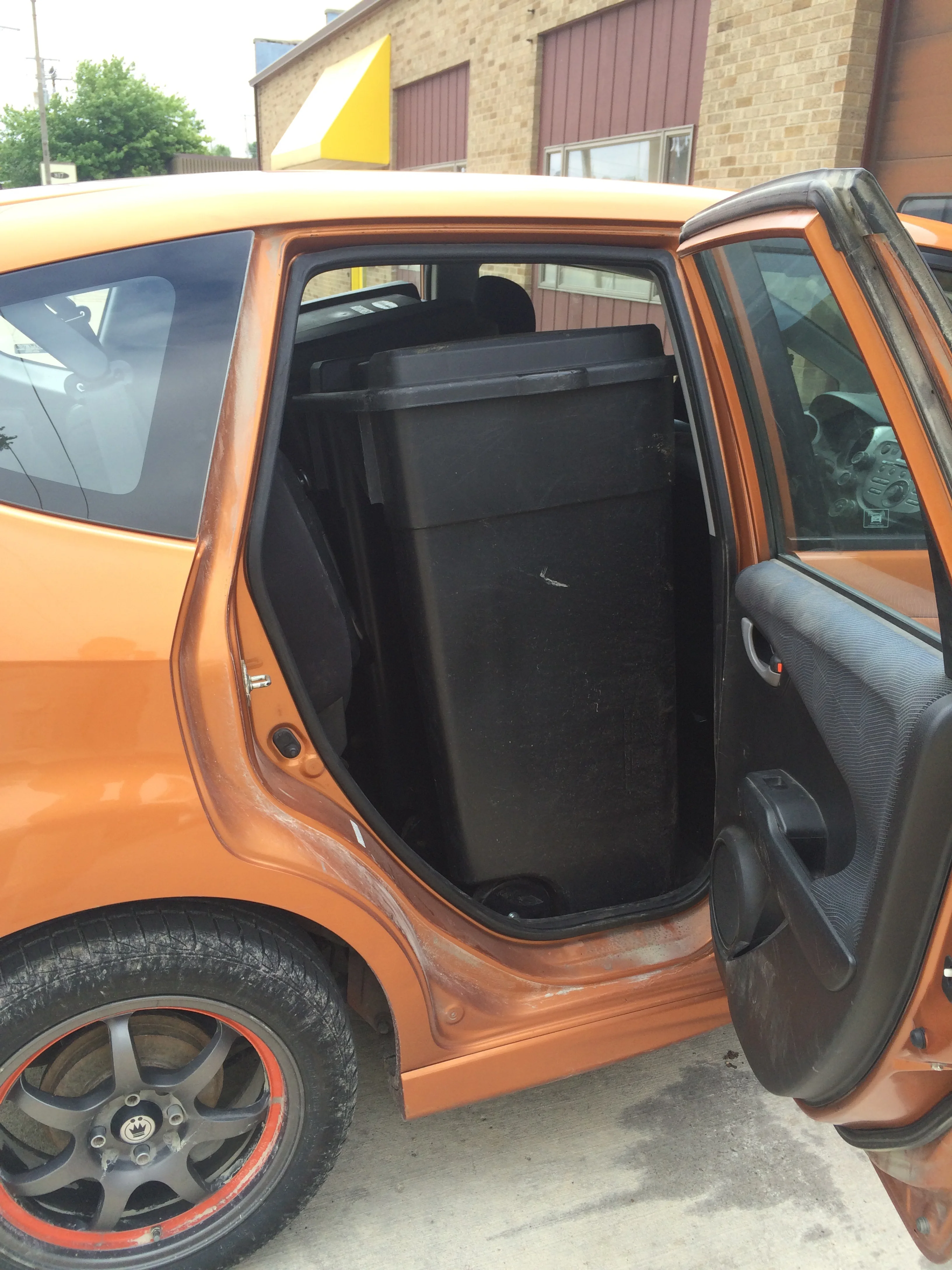 That's a pair of 50 gallon garbage cans standing upright in the back of the car...