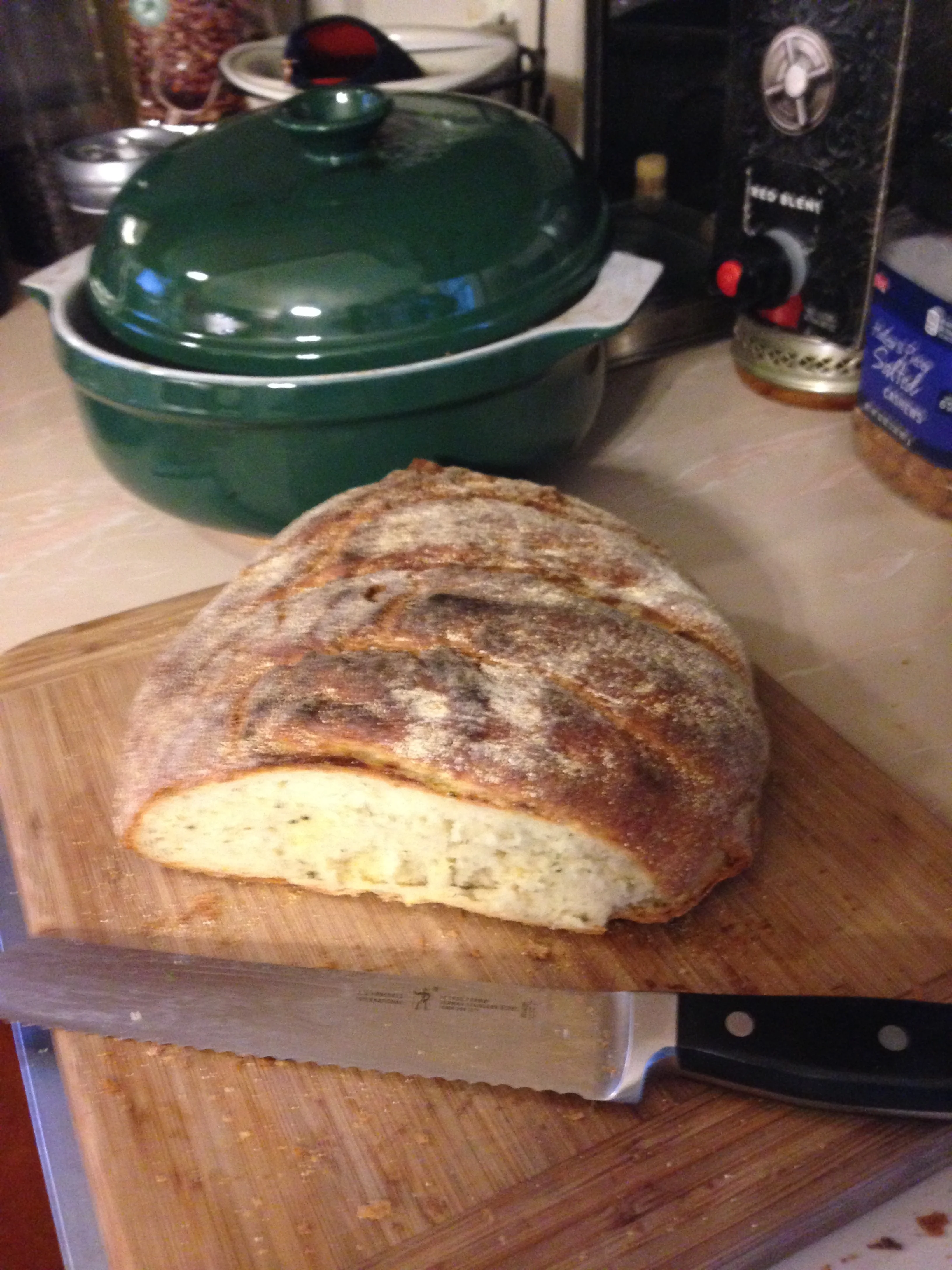 Rosemary Boule made with fresh rosemary from our garden. In the background is my Emile Henry ceramic Dutch oven, which makes a great crusty bread. I never knew a dutch oven could be used for bread making.