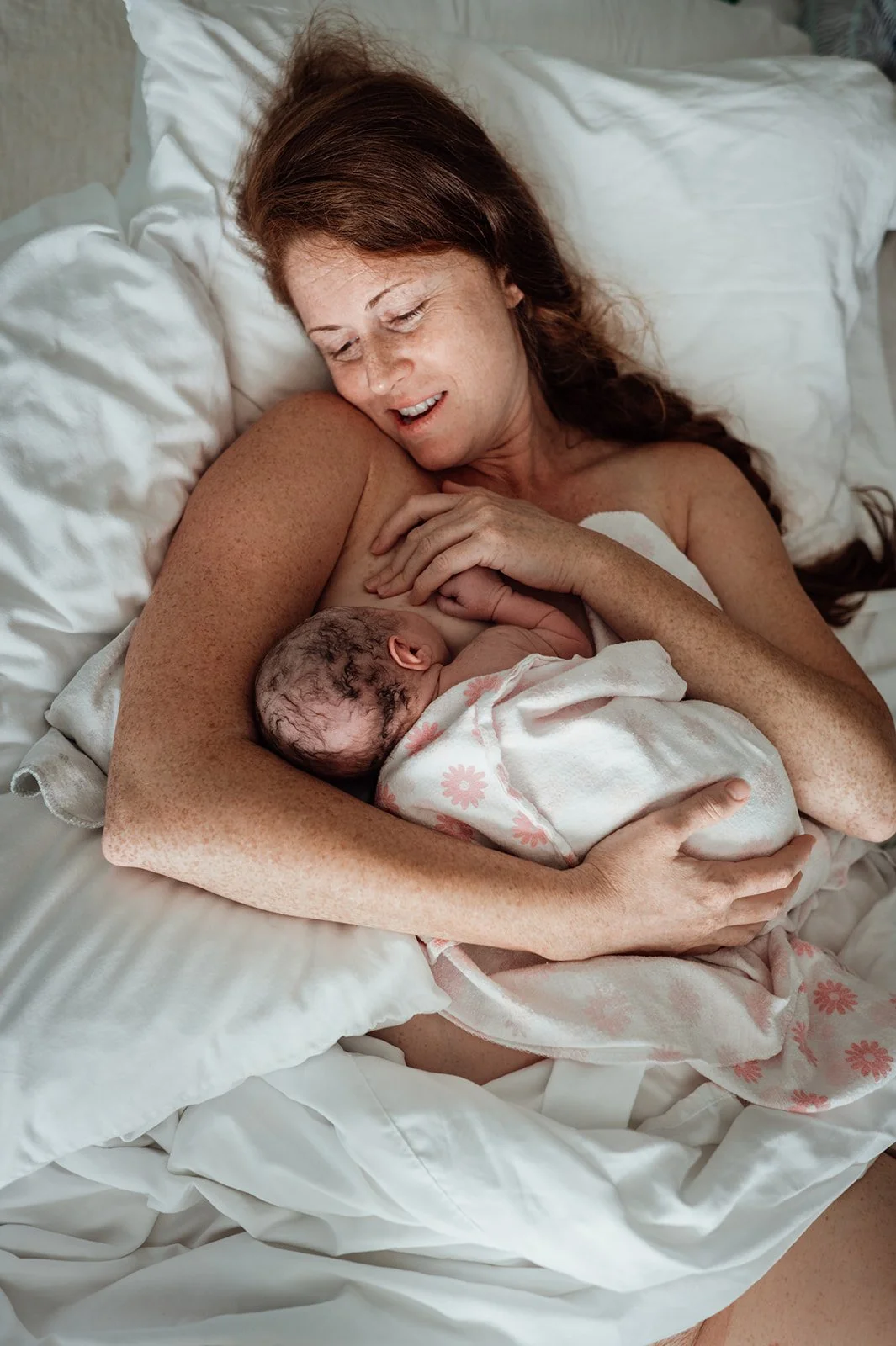 Mother Resting In Bed with Newborn