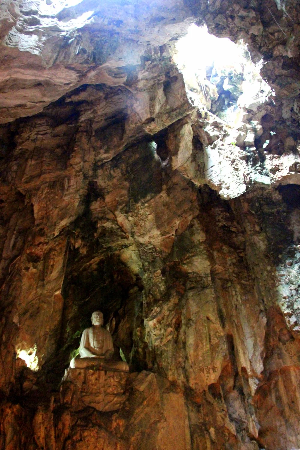 This photo can't do justice to the magnificent size of the cave-- the Buddha looks tiny but was gigantic!