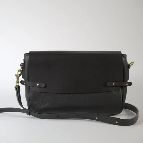 Mini Satchel - $440.00 Available in Black and Tan The Mini Satchel is the perfect sized shoulder bag and the horizontal layout makes accessing the contents a breeze. The flap and strap are made from a smooth Italian vegetable tanned bovine leather. The body is made from dry milled vegetable tanned bovine leather that has a small pebbled grain appearance, created by artisan tanners in Tuscany. The satchel is fully lined with a natural cream coloured lightweight canvas in 100% cotton. There is a zip pocket as well as a double leather trimmed phone sized pocket. Quality craftsmanship, made with care and attention to detail. The Satchel is locally designed and made in Melbourne by Japanese trained leather artist, Sarah. DIMENSIONS: 30cm x 7cm x 19cm (LWH) STRAP: 2cm (W)