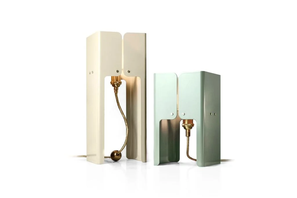 Hashtag Lights Tall - $450.00 Short - $430.00 Table lights - is a little family of sleek decorative table lights that merges Art Deco elements with industrial vintage components while maintaining a contemporary feel. Dimensions Tall - W 150mm x D 150mm x H 390mm Dimensions Short - W150 x D 150mm x H 260mm Materials Shade - Powder Coated Aluminium Lampholder - Brass Cable - Gold Metallic Woven Cotton Colours - Pottery Beige, Pale eucalypt and Ace Black