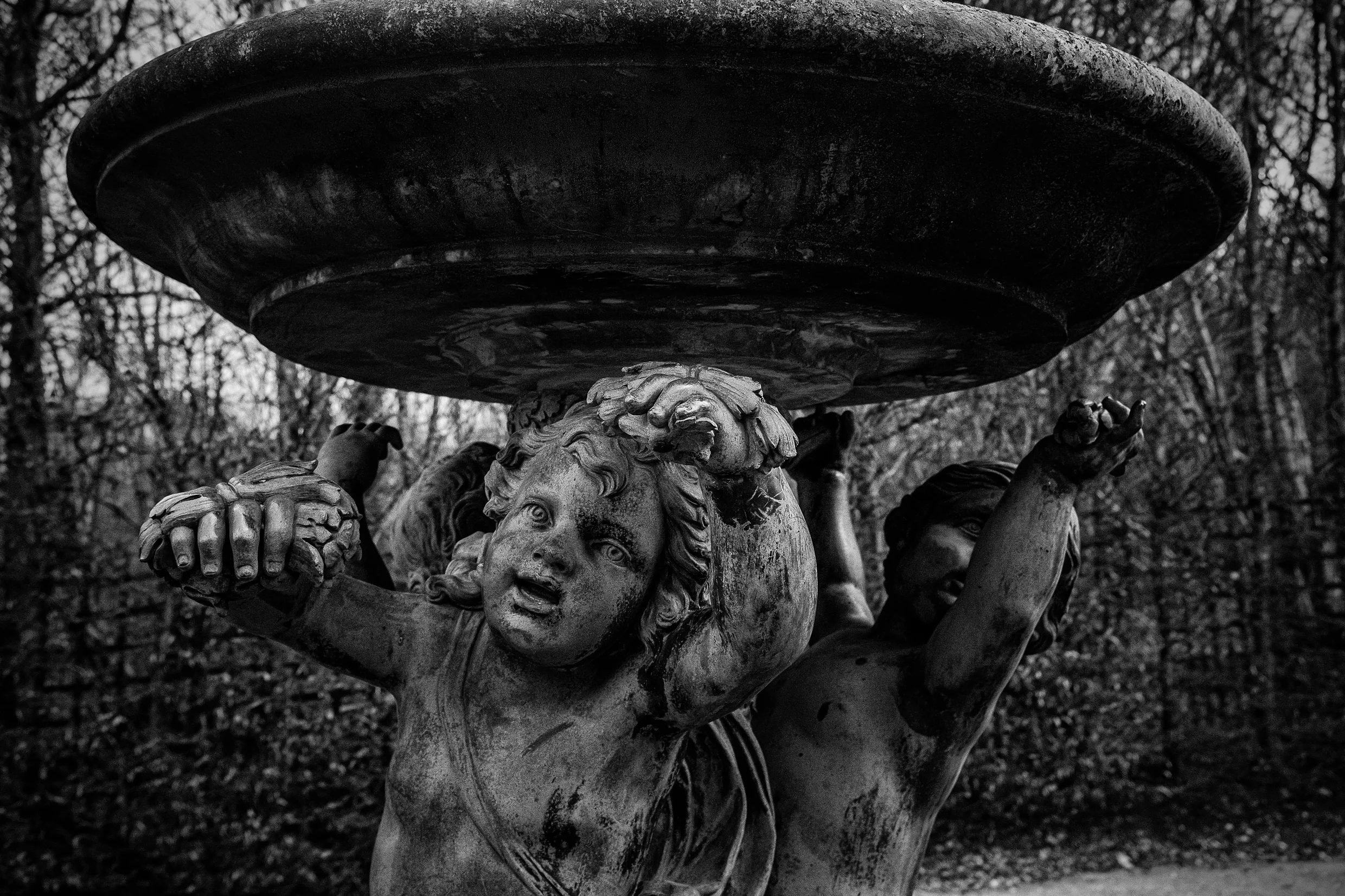 An image made on a very cold (freezing) afternoon in the garden of Versailles. This is one of the very few pieces that are not covered for protection. It is incredible to see the expression on these statues. An amazing work of sculpture. Camera: Fujifilm X100s