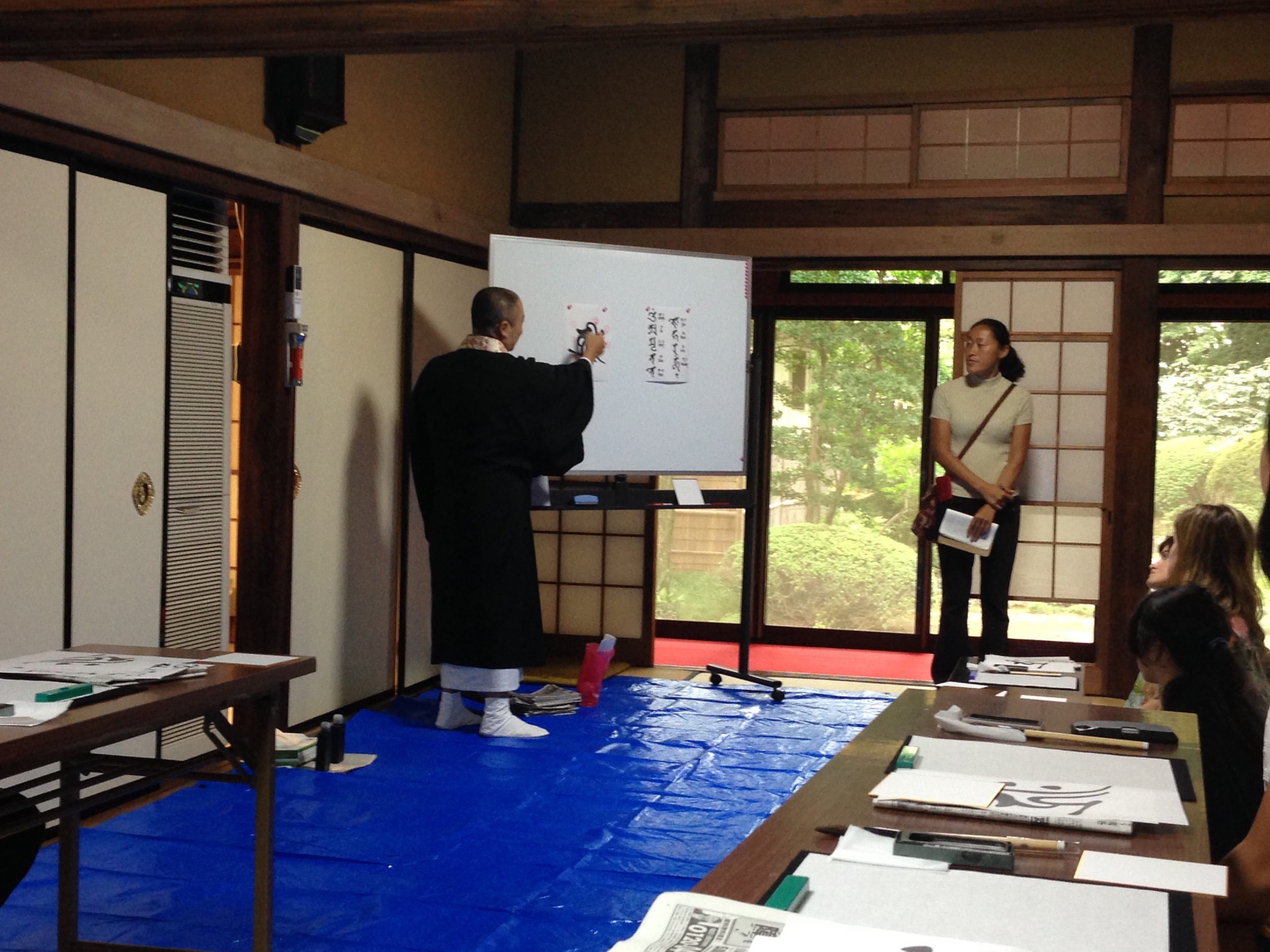 Teaching us calligraphy. 