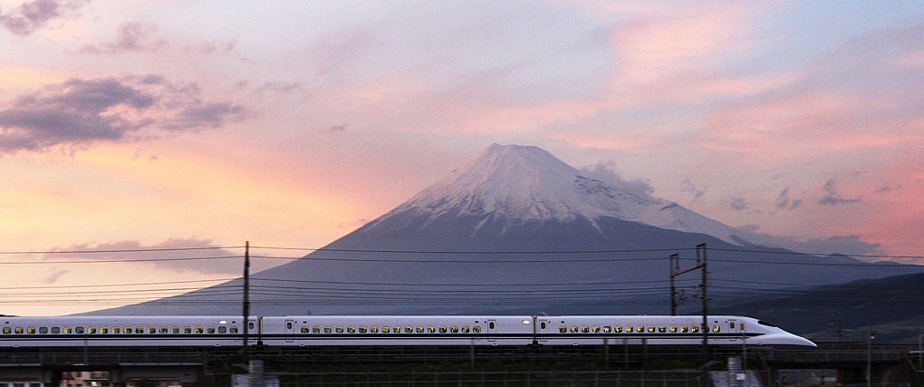 A shinkansen train passes by Mount Fuji in Shizuoka Prefecture.