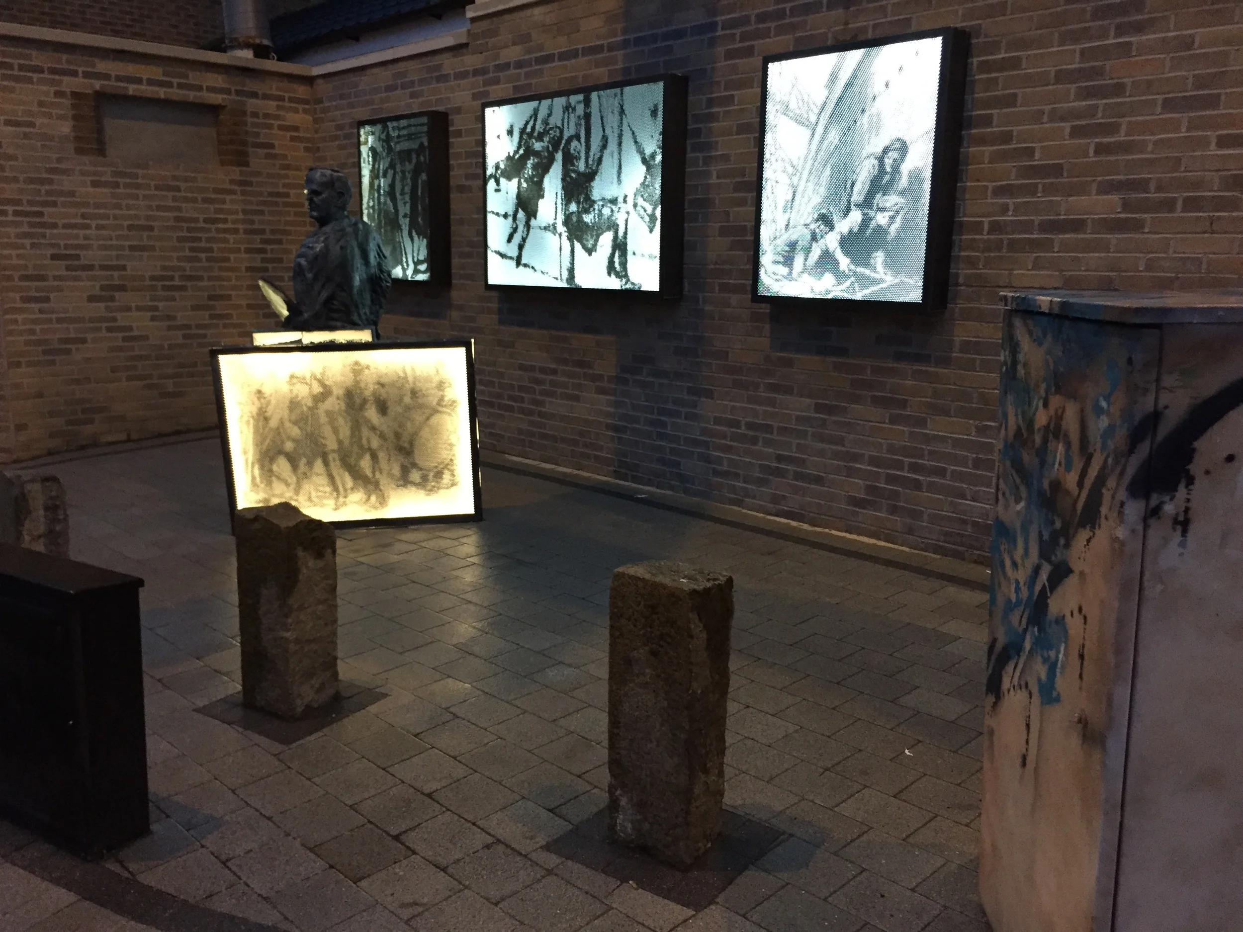 The site by night with illuminated images of Conor's work