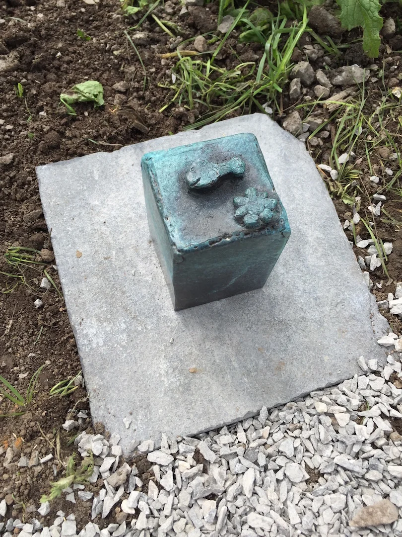 One of 14 path markers modelled and cast by the community
