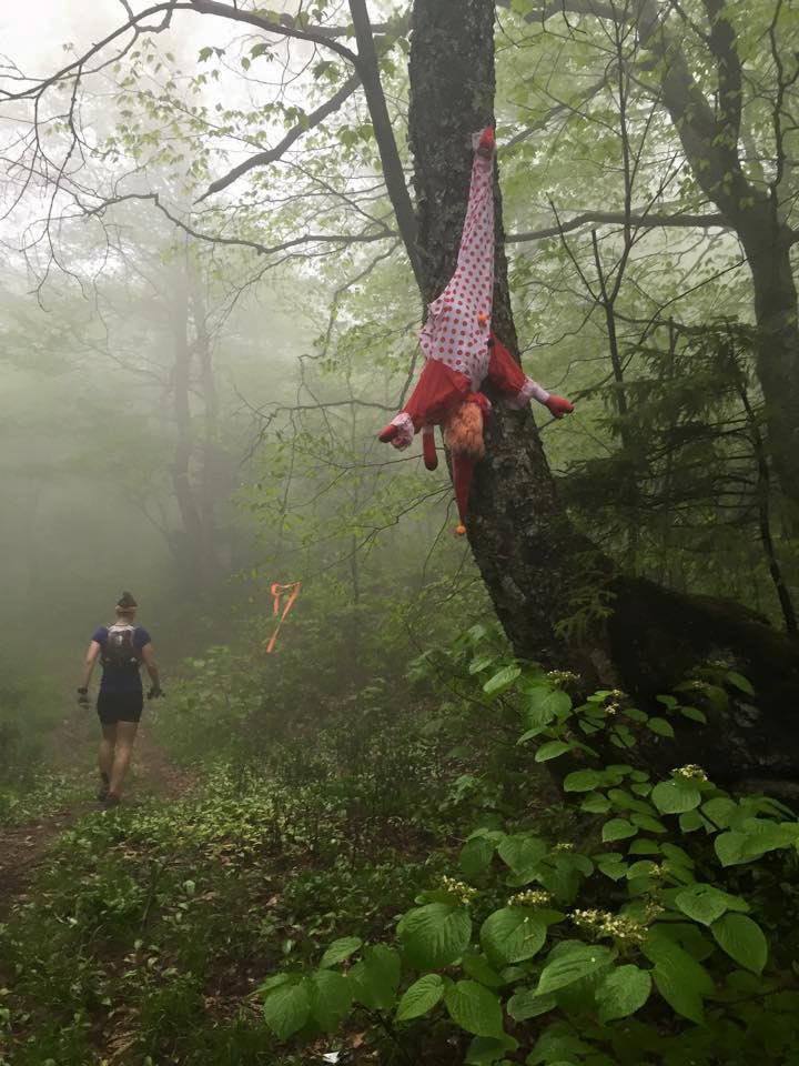 Jordan passes a clown dangling from a tree at the top of Mt. Romance.