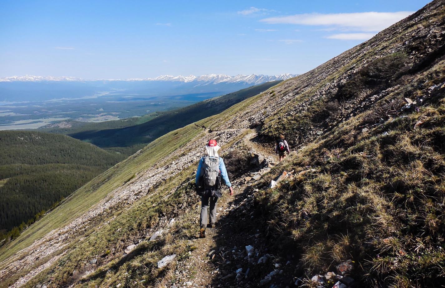 Corey White and Meg Roussos descend a mountain flank above Colorado's Sanford Basin.