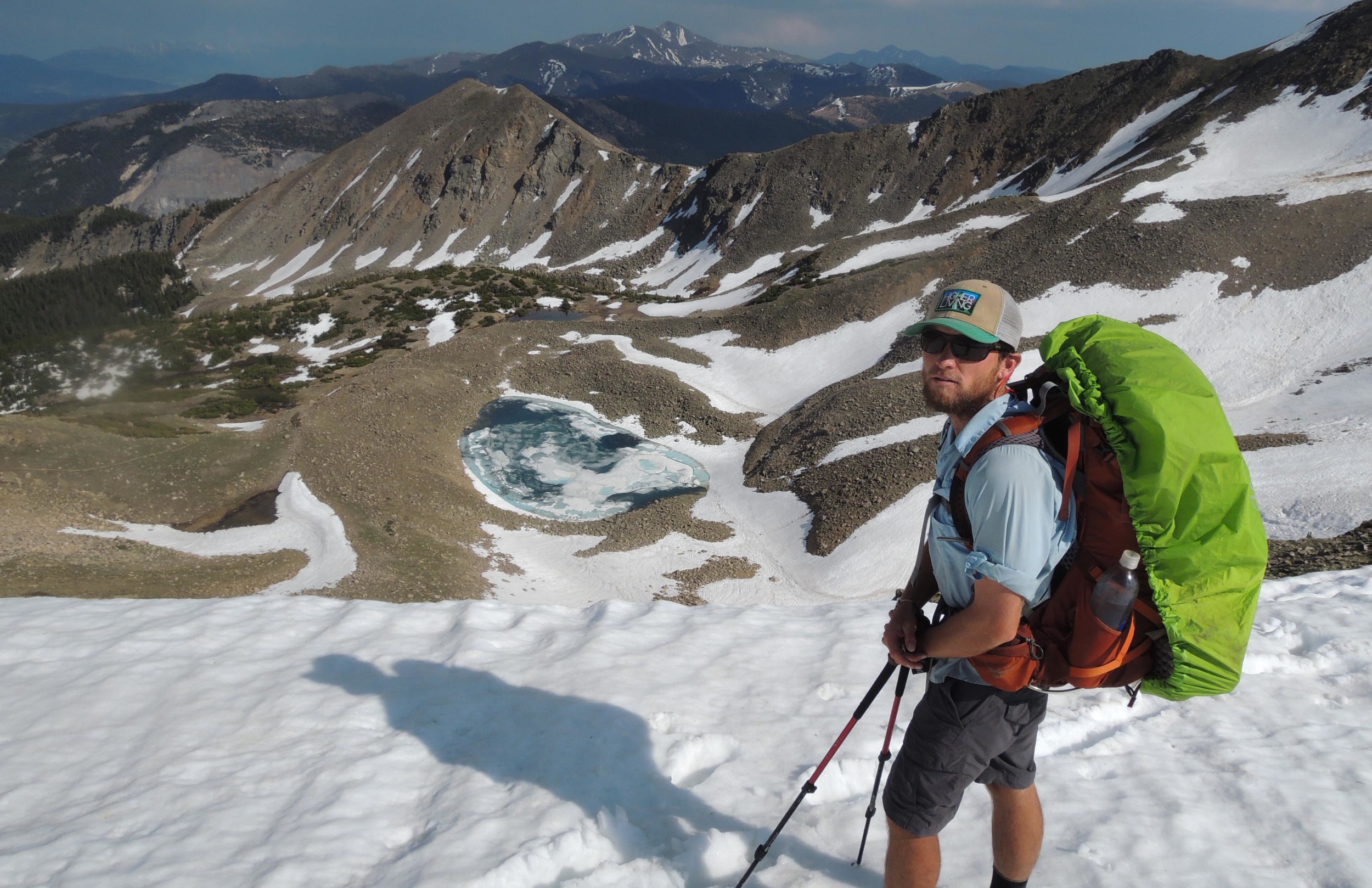 Chilton Tippin stands above a snowfield near Monarch Pass, Colorado.