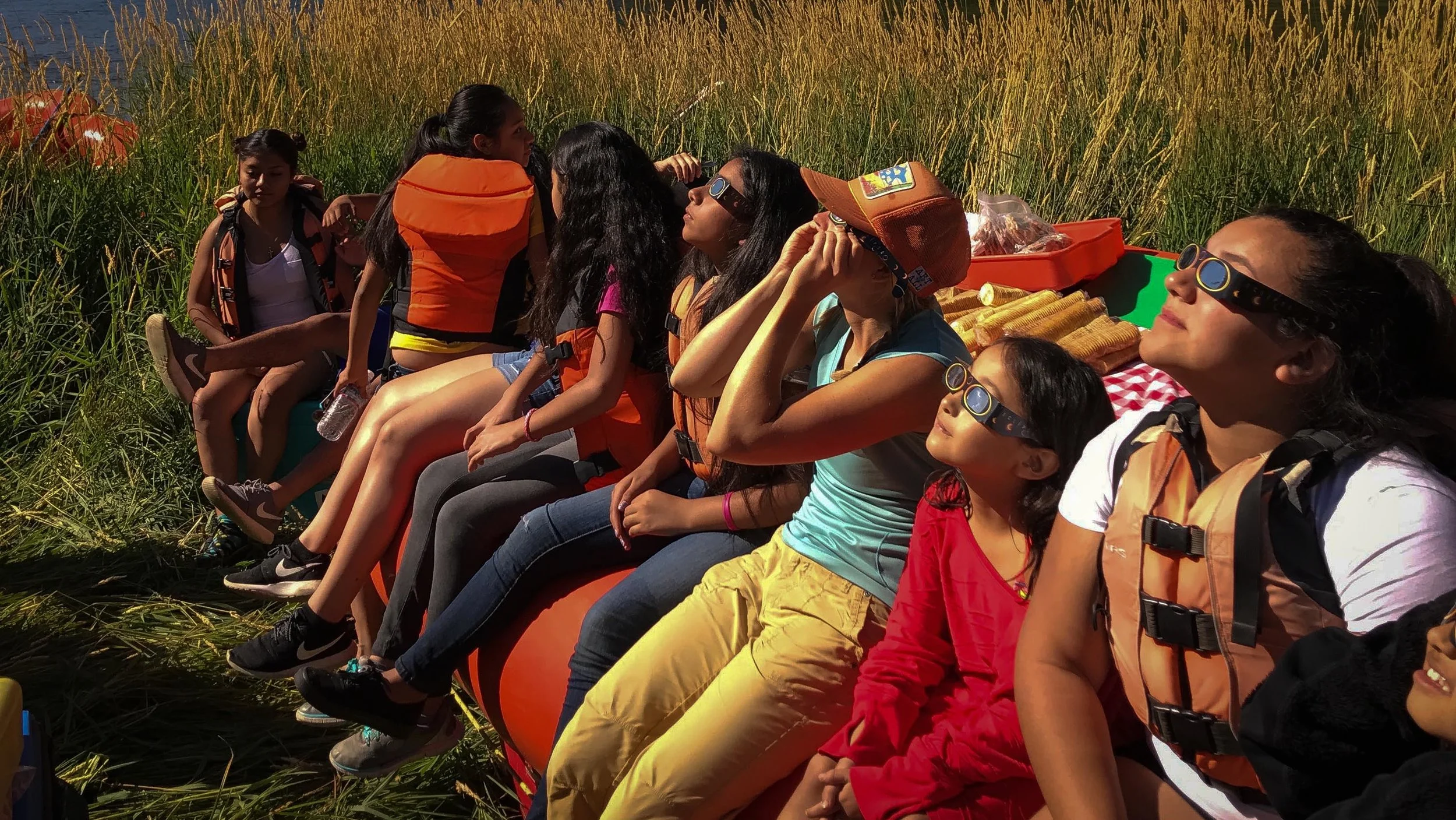 STUDENTS WATCH THE BEGINNING OF THE 2017 SOLAR ECLIPSE ON THE NORTH FORK OF THE PAYETTE RIVER IN IDAHO. (PHOTO COURTESY KAYLA BORDELON)