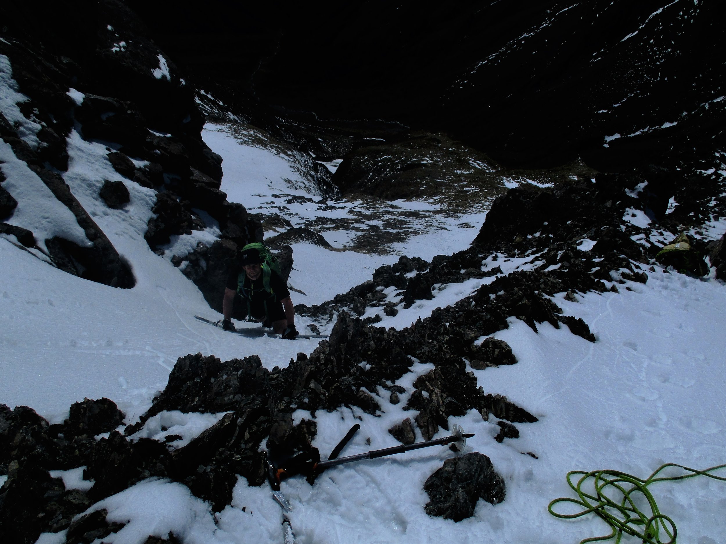 Brent climbing a steep snow gully