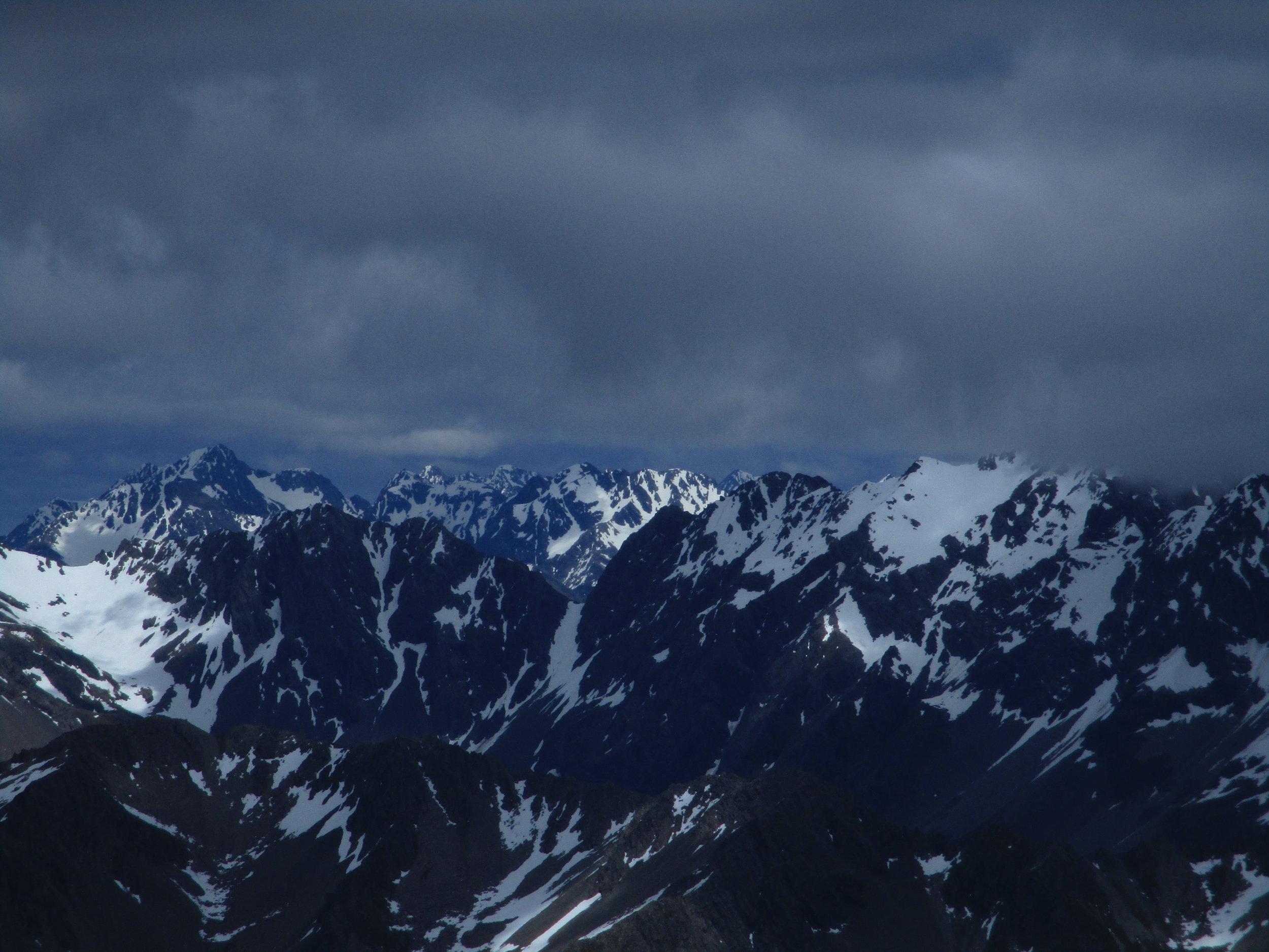 Looking South , the impressive Mount Una in the Spenser mountains is center rear view behind the other mountains.