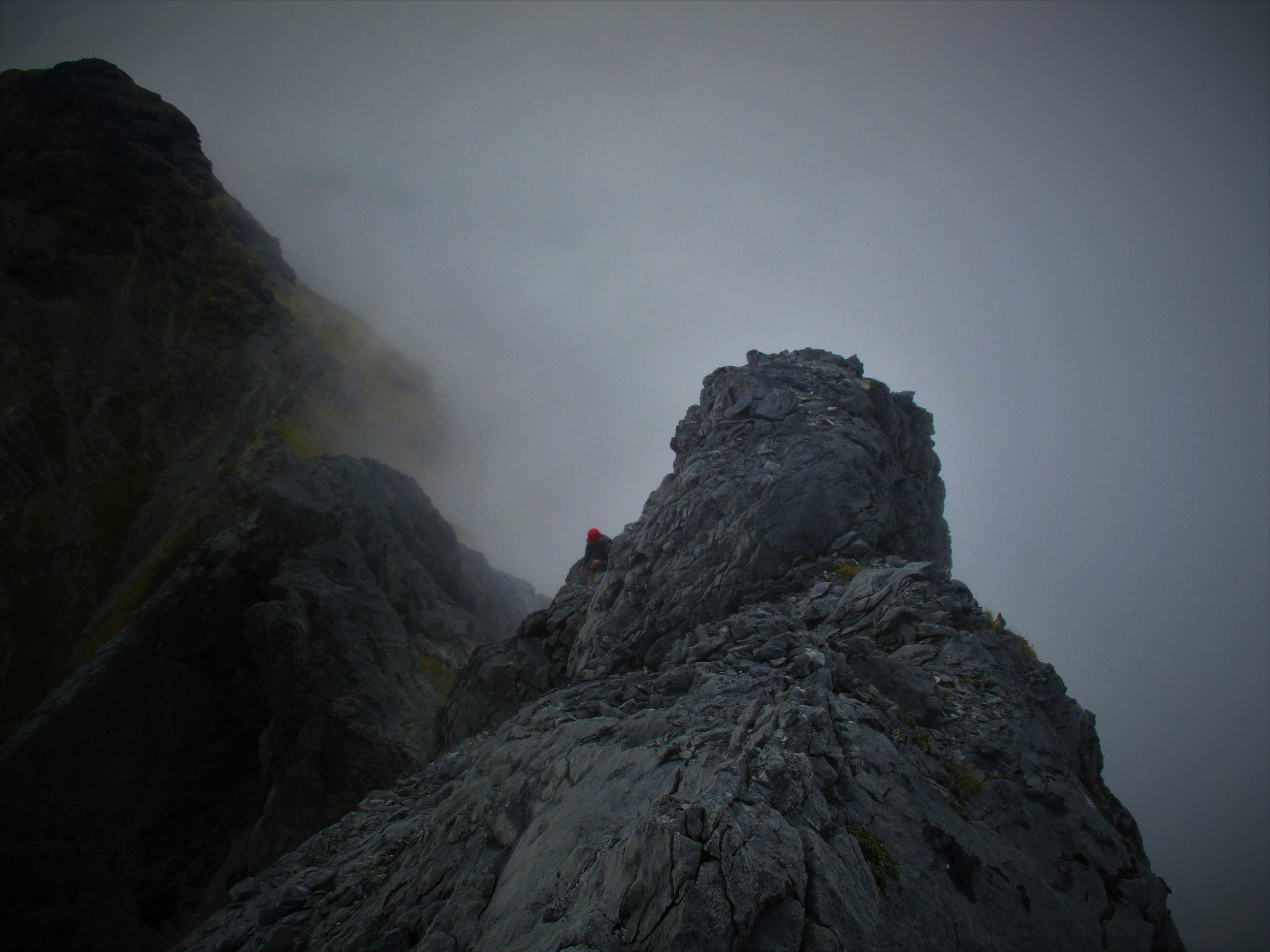 Curtis searching a route on the North Twin 