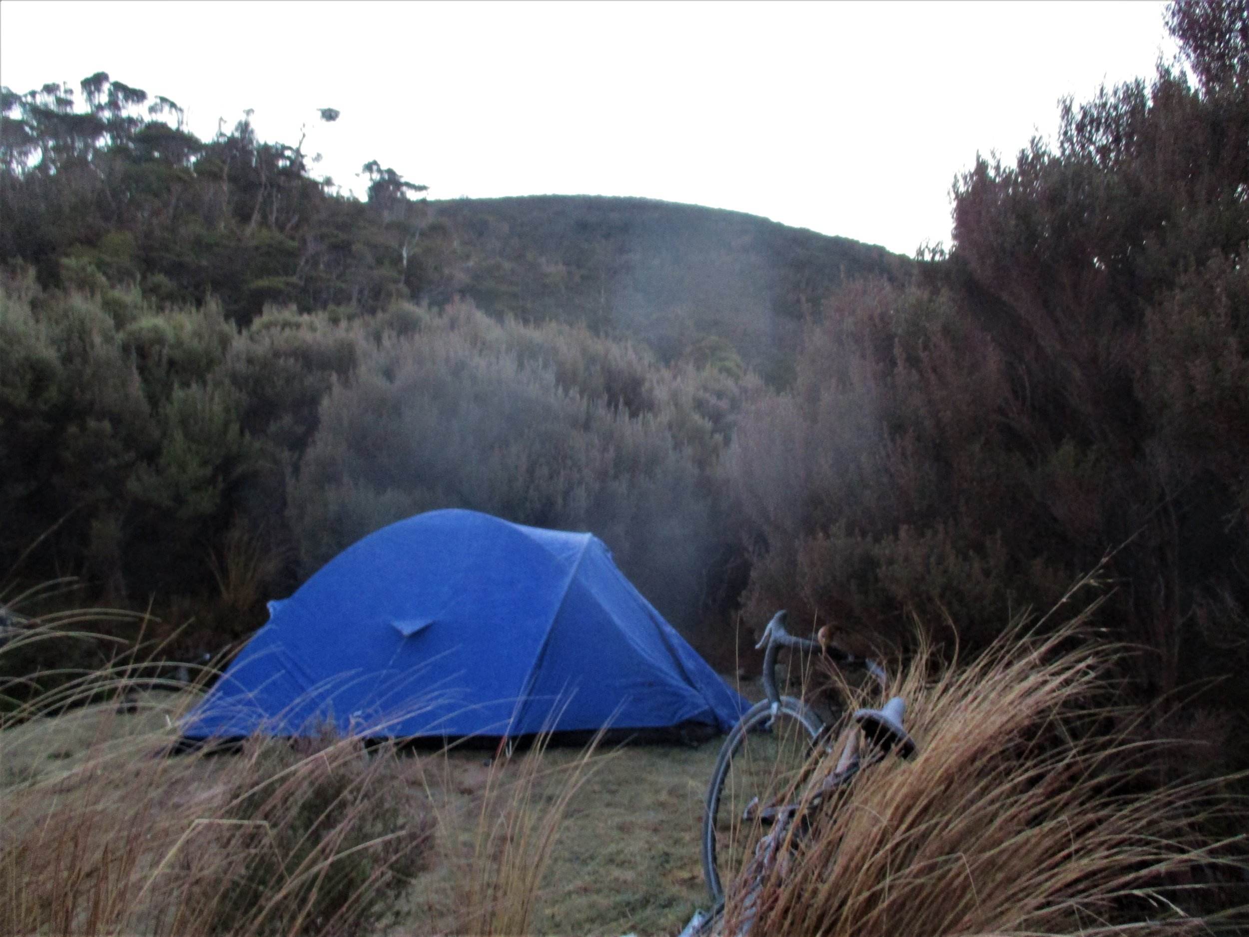 Testing an older style Katamandu XT tent I bought to replace the sponsored one I lost to a glacier in Pakistan . The old XT is a light weight no frill version and so far in testing (here on the Perry saddle with the Colossi after a snowy and icy night) has proved very warm