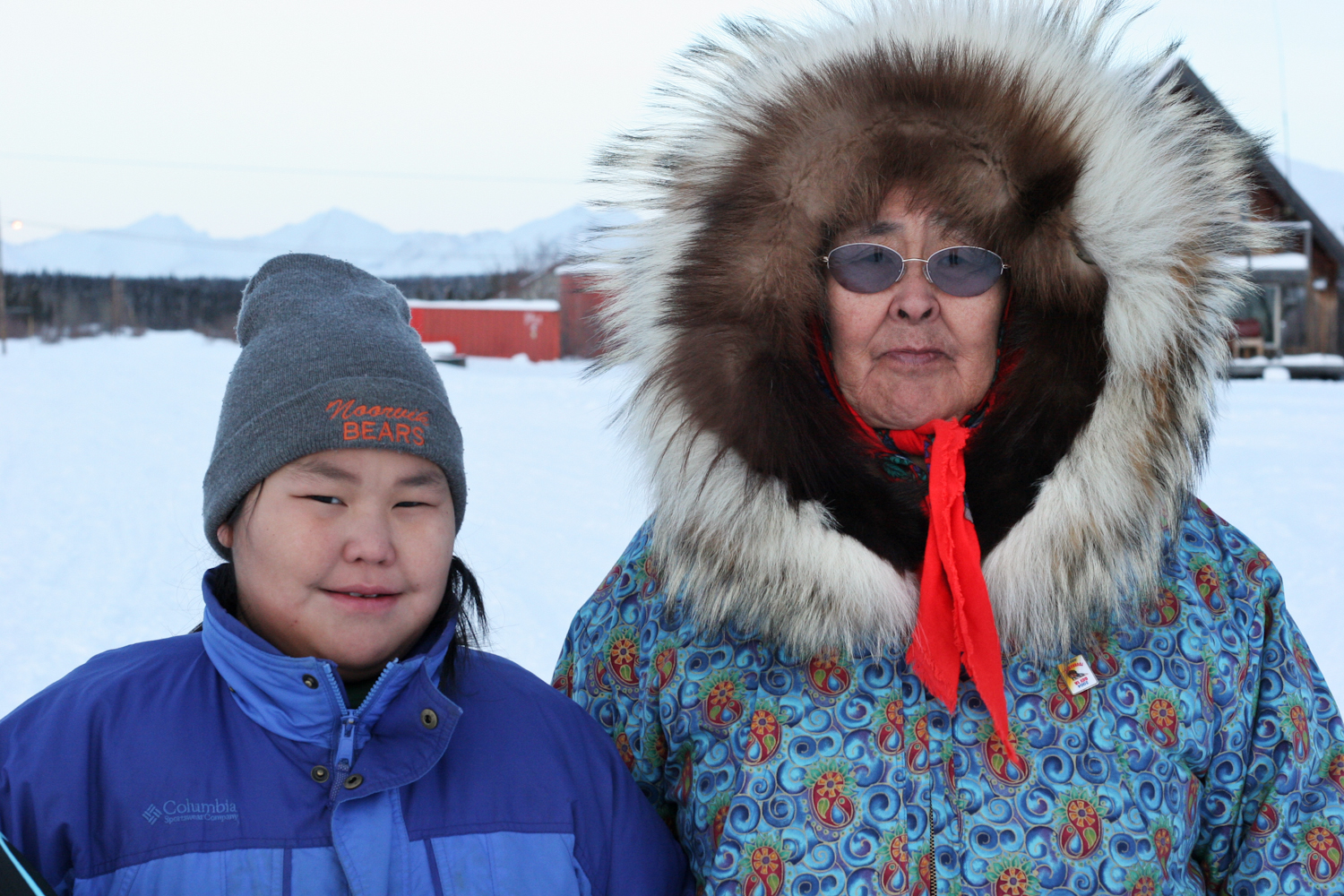   Irene Armstrong, Ambler's preacher, wears a handmade fox fur and wolf parkee, a style worn by most of the elders. Coumbia jackets like her granddaughter's mark the shift in Inupiaq culture towards an emerging Western influence.  