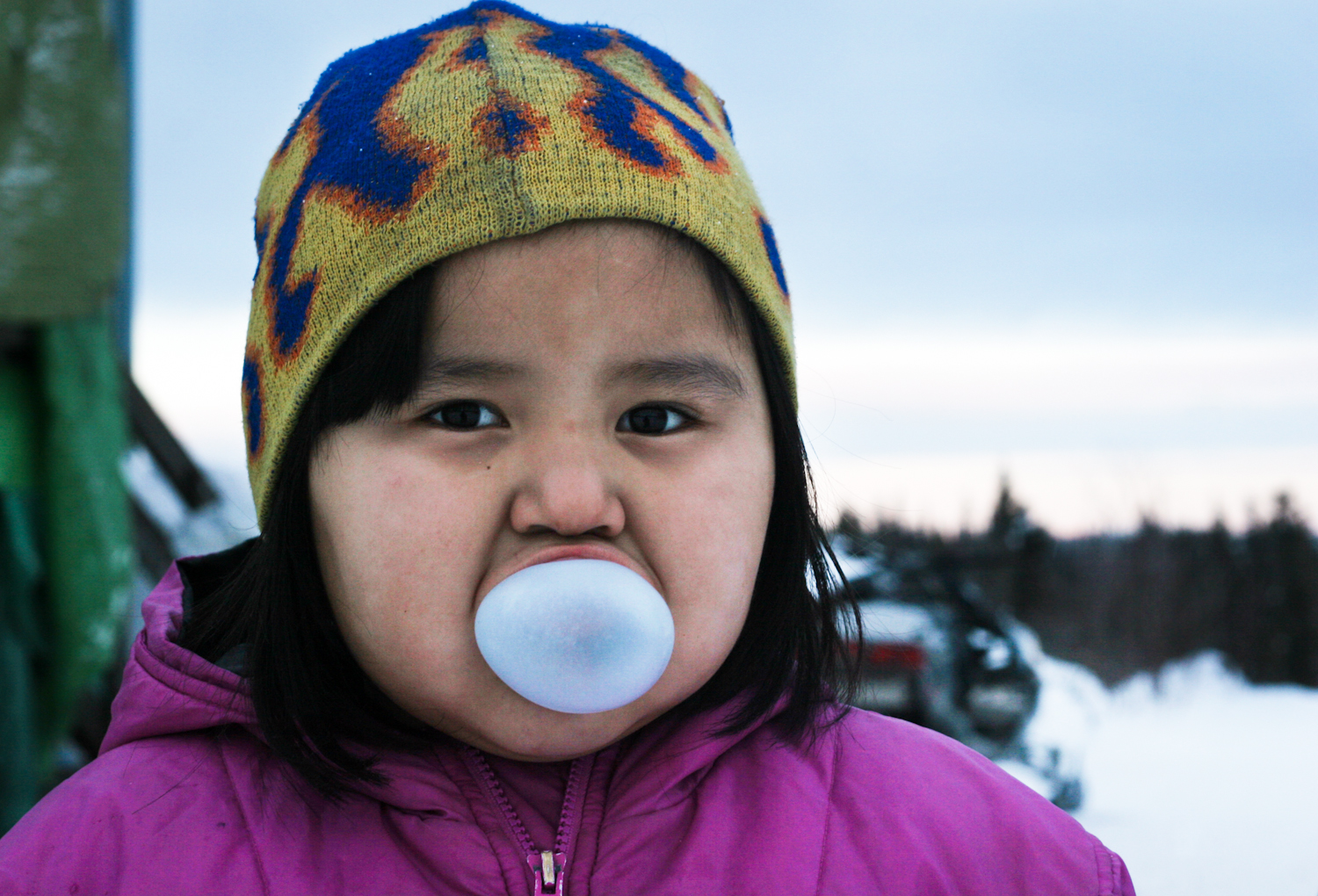   Alice Brown, 6, blows a bubble outside in negative 20 temperatures.  