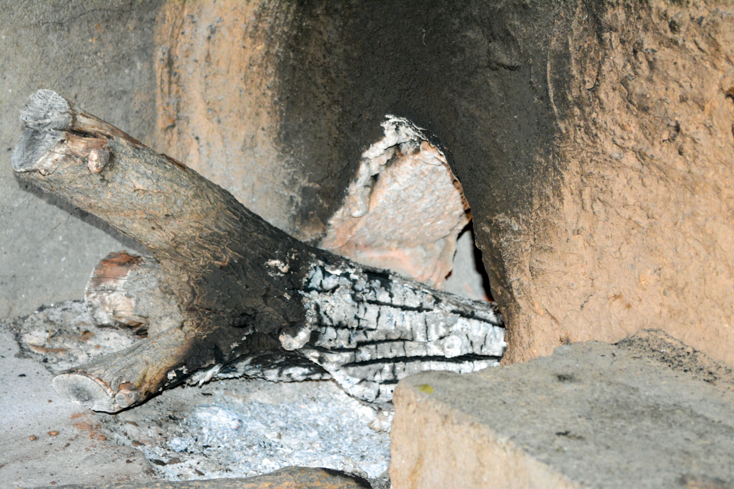 The stove entrance to push logs through.