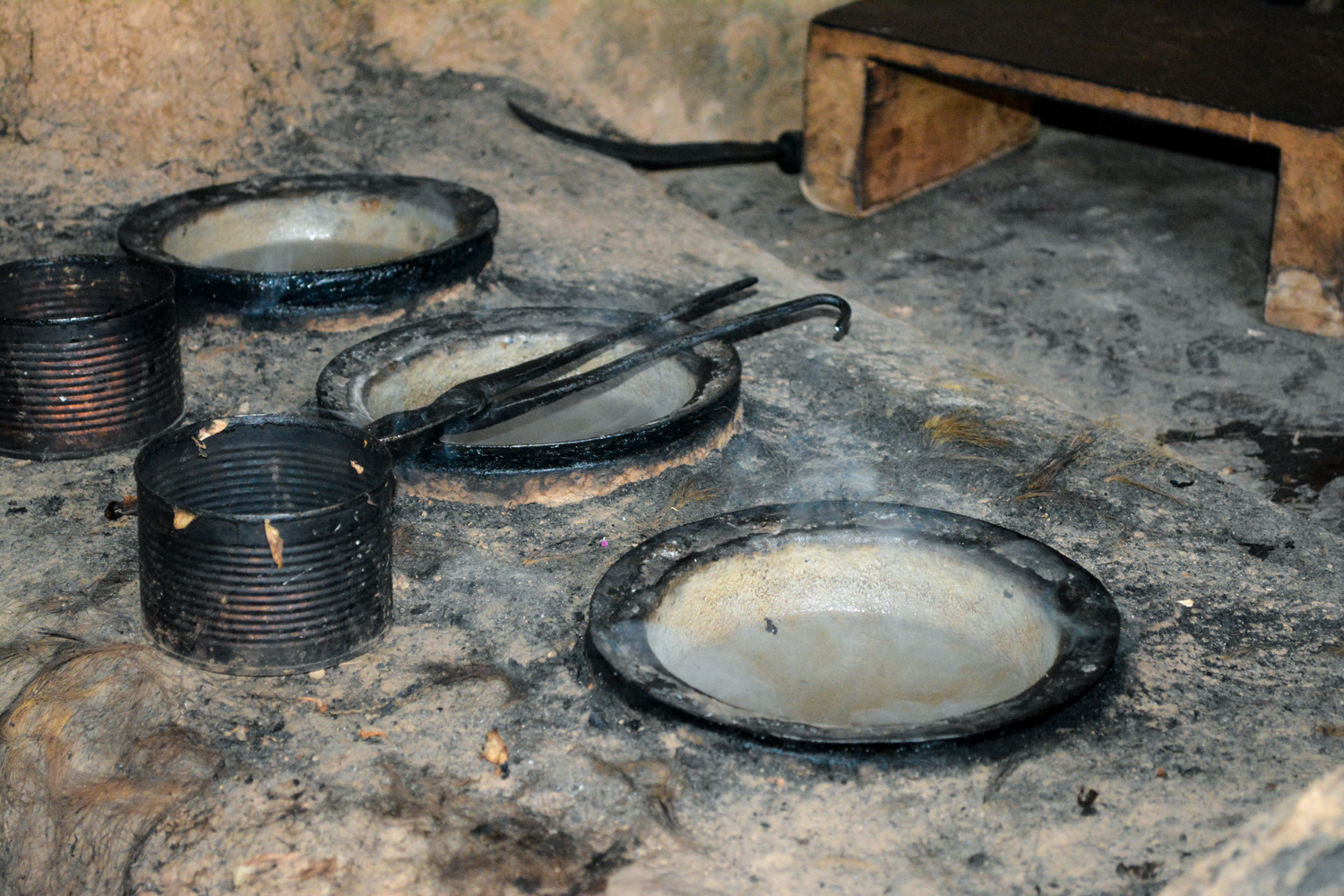The tops of the cauldrons that are inset in the stove.