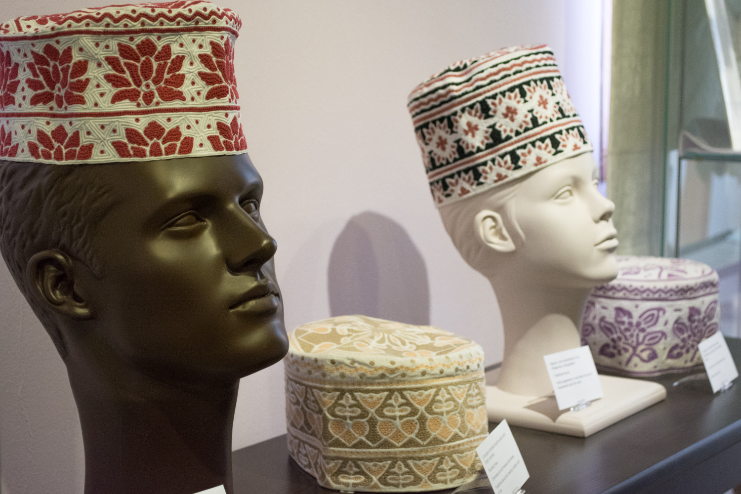 The kuma can be worn alone or under the massar. The embroidery design of the kuma is very specific. The three in the foreground have traditional style embroidery patterns. The side of the cap has a full band of the design around the top and a half band of the design around the bottom.