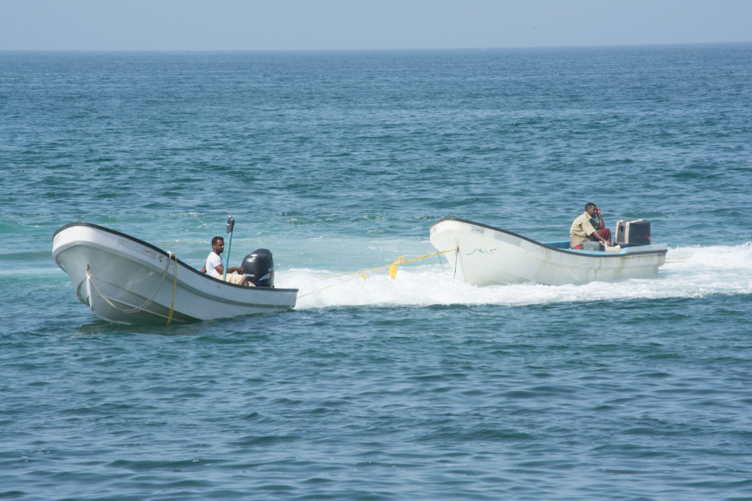 Fishermen relaxing while they wait to be pulled along.