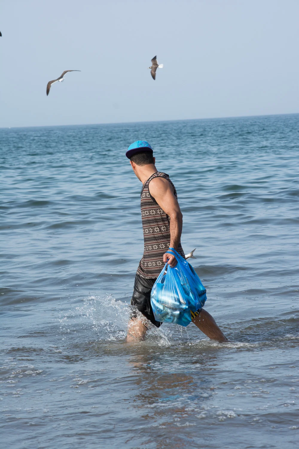 Fisherman carrying his dinner home.