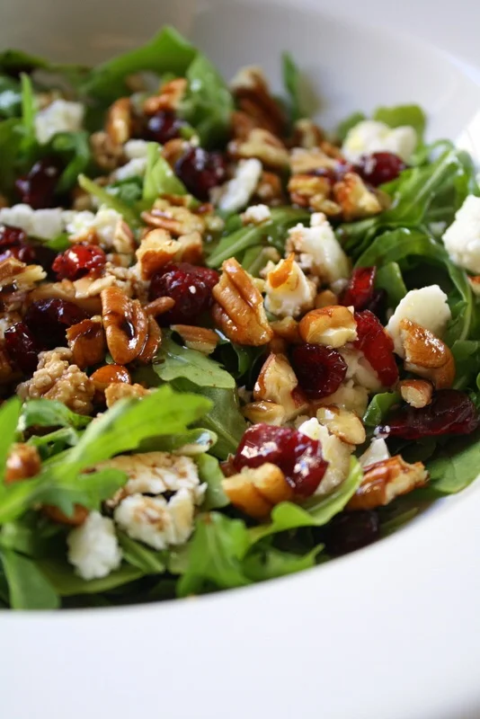Get the recipe here: http://kalisasorexi.com/2010/10/baby-arugula-cranberry-pecan-and-feta-salad/
