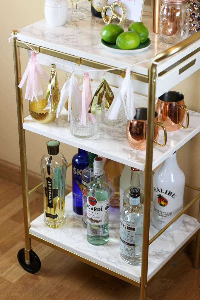 This Gold and Marble Bar Cart is actually a genius Ikea hack by bloggers Britta and Carli Garsow. It started as a simple Ikea utility cart, and with a little spray paint and marble contact paper, they turned it into this beauty!