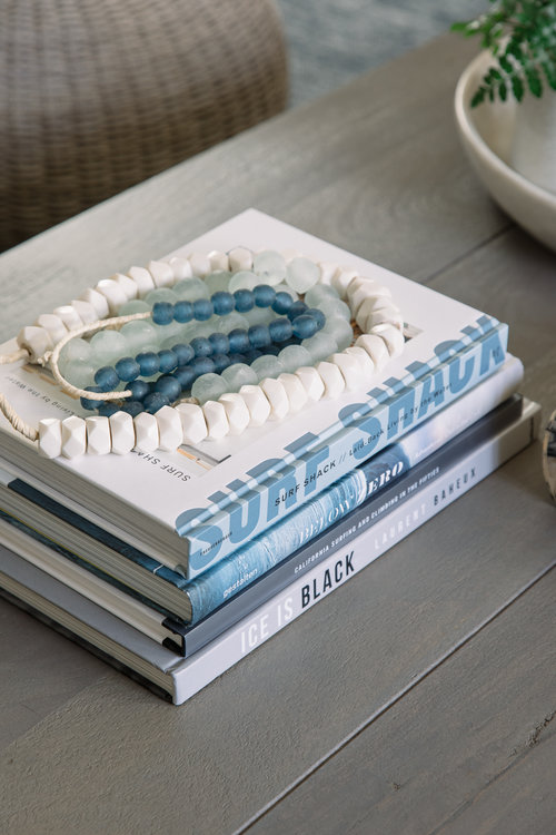 Seaglass beads as decor on the coffee table bring something unique into the design that actually came from the ocean.