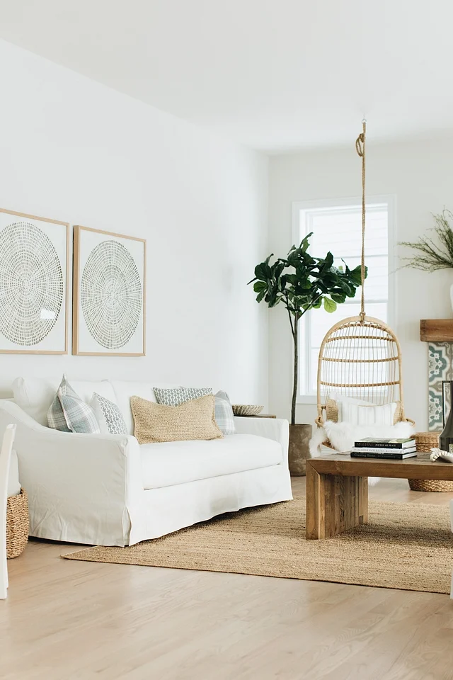 I’m loving the zen artwork on the walls and the minimalist framing that echoes the natural shades of the room. The sofa also has that perfect coastal farmhouse vibe that looks like a white sand beach but also makes you want to cuddle up in front of the fireplace on cold winter nights.