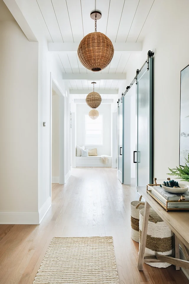 This hallway view shows the huge variety of textures the designer made work seamlessly in the space.