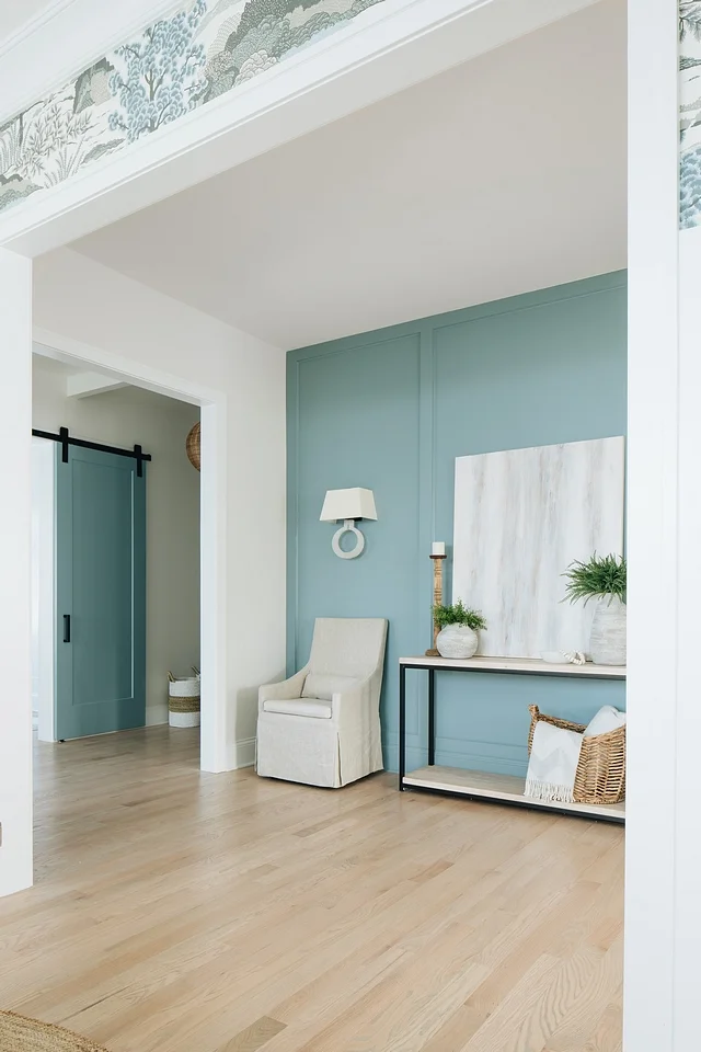 The aqua paneling echoes through the home to coat this entire wall.
