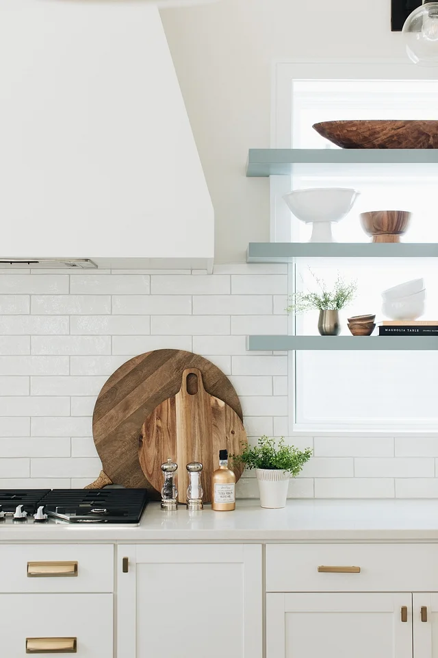 Cutting boards like these can provide excellent decor in an all-white kitchen. The contrast of the dark natural wood really stands out.