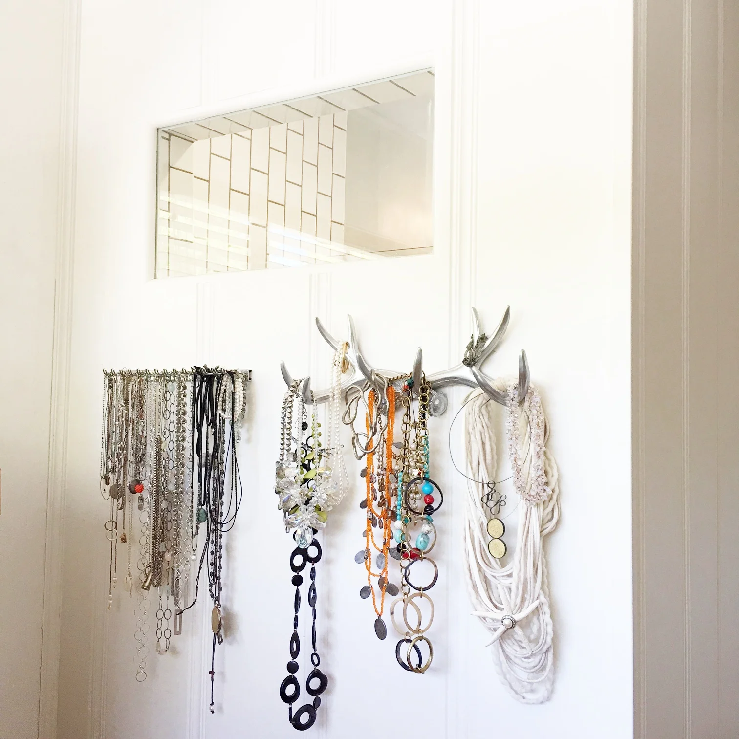 Here is the shower window and a new wall to hang my necklaces (which I have a few of). The one on the left is actually a men's tie holder. The one on the right is a silver painted set of antlers. How cute is that? I got it from my bestie for my bday. 